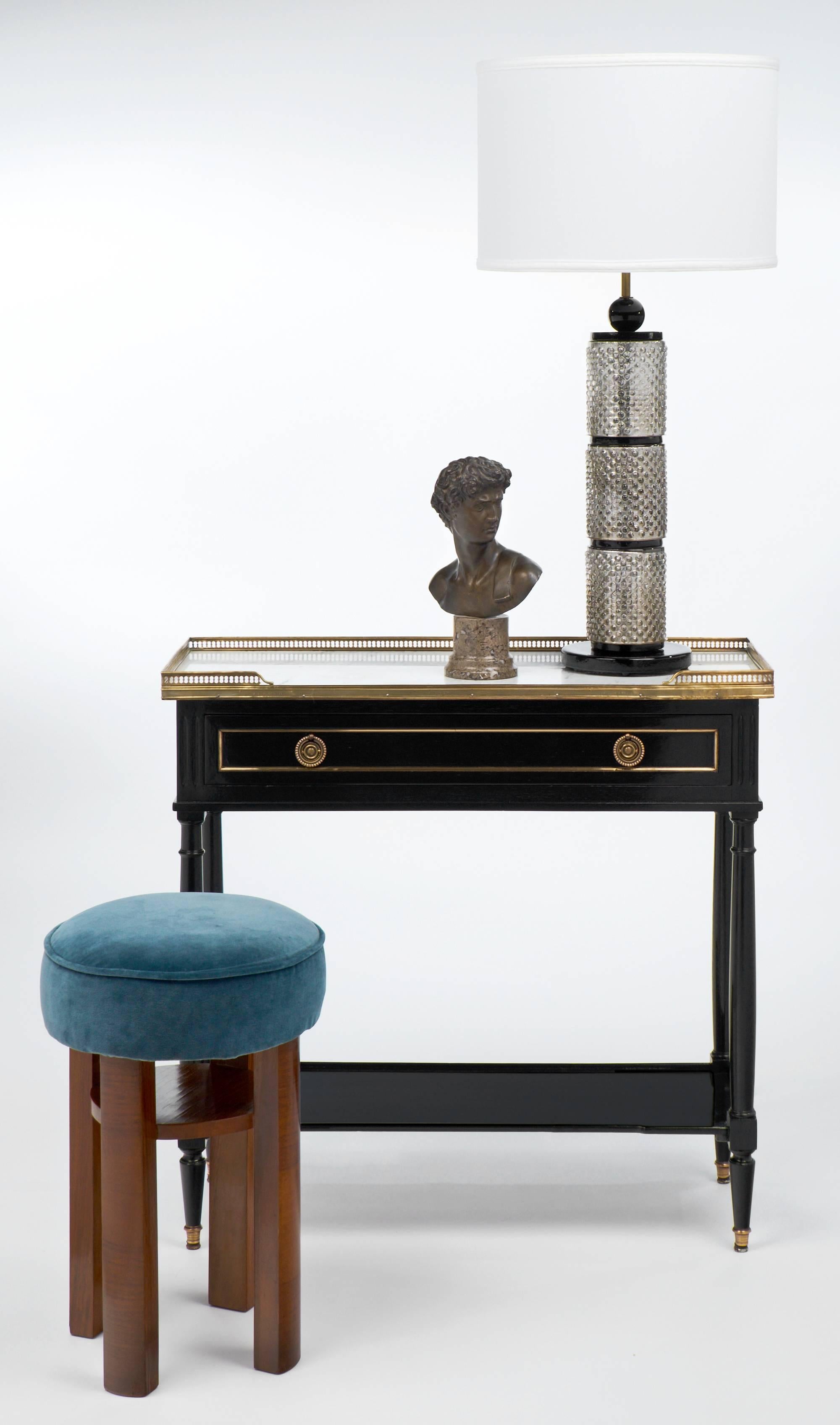 Antique French Louis XVI style console table or end table of ebonized mahogany with a hand-rubbed French polish finish, brass trim, and Carrara marble top. A long, dovetailed drawer with bronze pulls, and a bottom shelf for open storage or display.