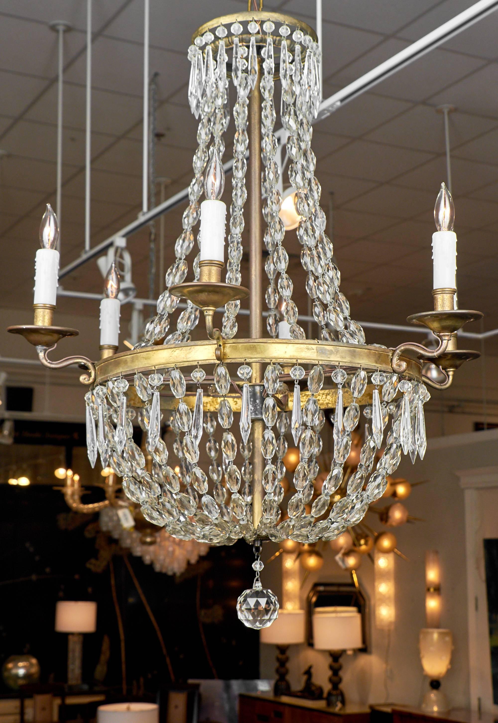 Stunning French Empire style chandelier with six candelabra lights. This light has been rewired for the US. The height with the included chain and canopy is 60.75