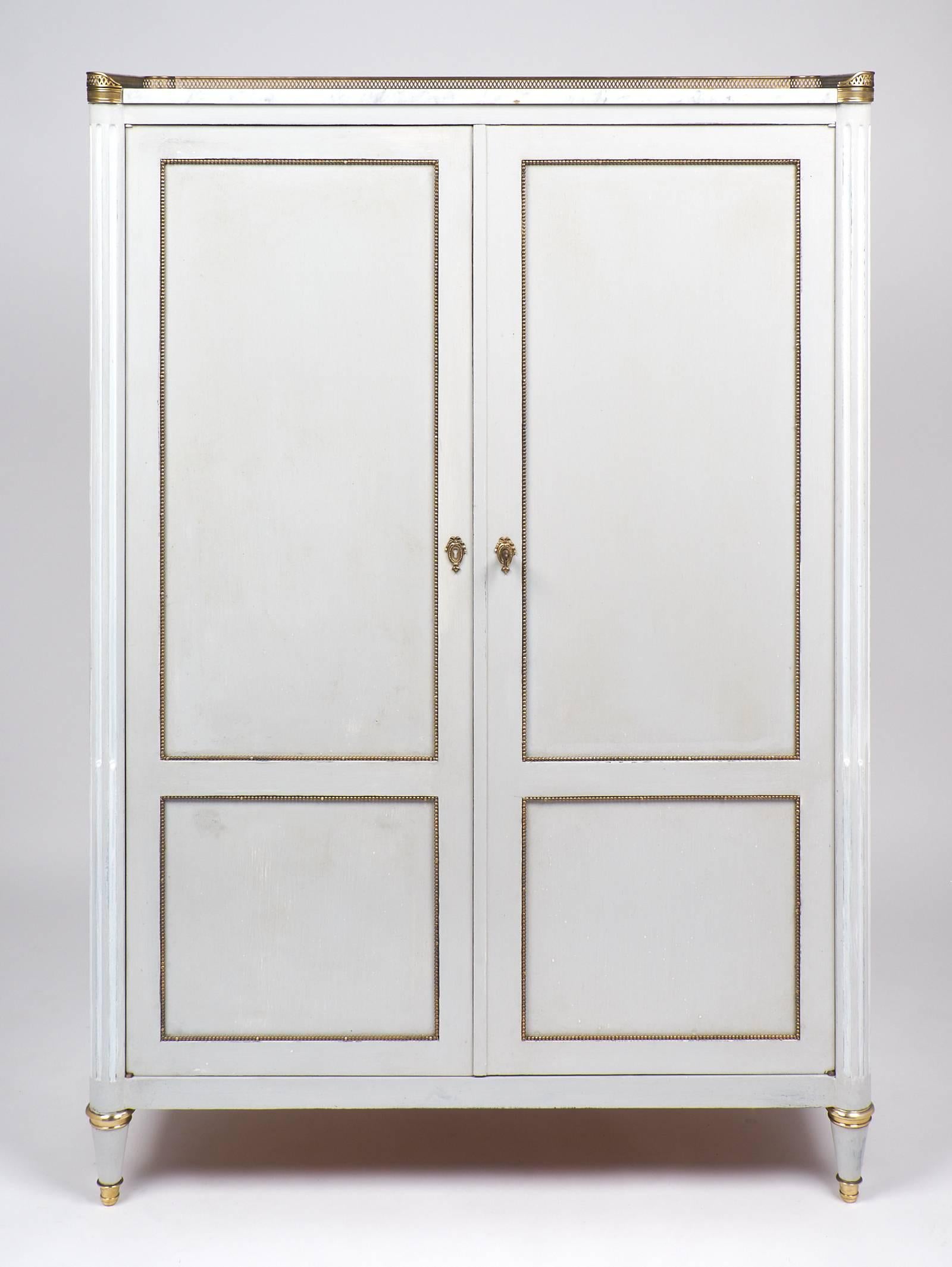 Antique mahogany Louis XVI armoire by Chaleyssin, from Lyon (signed in the back).
Carrara marble-top with an opened brass gallery. Brass hardware and feet, brass trims throughout, a superb construction for a great looking and efficient storage piece.