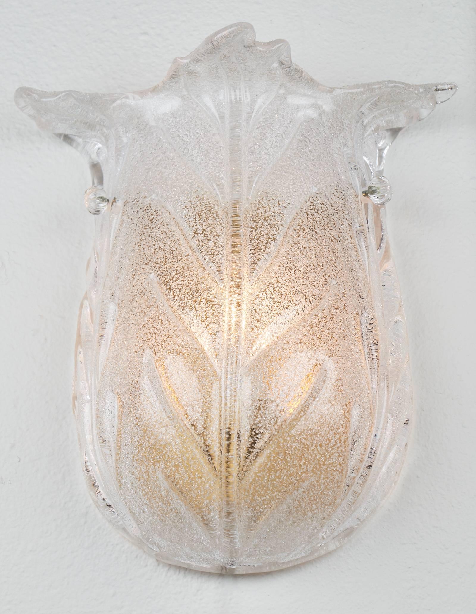 Beautiful tulip shaped sconces made of handblown Murano glass, using the Pulegoso technique which leaves small bubbles in the glass. These delicate looking sconces are so lovely and simple, but bring a lot of class and elegance to a space. They have