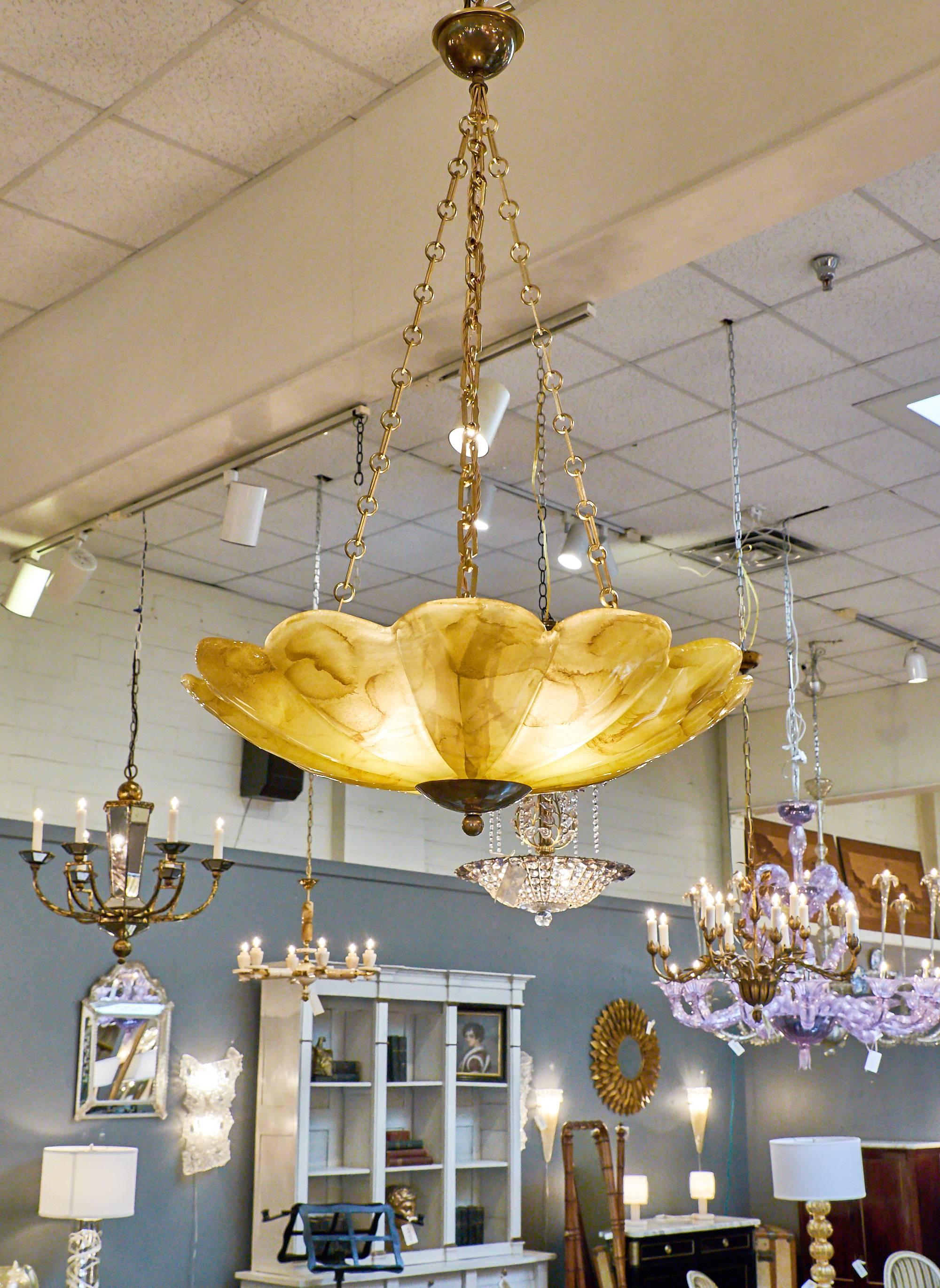 Lovely amber and gold colored Murano glass make this hanging pendant shaped fixture so unique. The glass, handblown and in a floral shape, hangs from three chains attached to a brass canopy. This wonderful piece glows a warm honey color when lit,