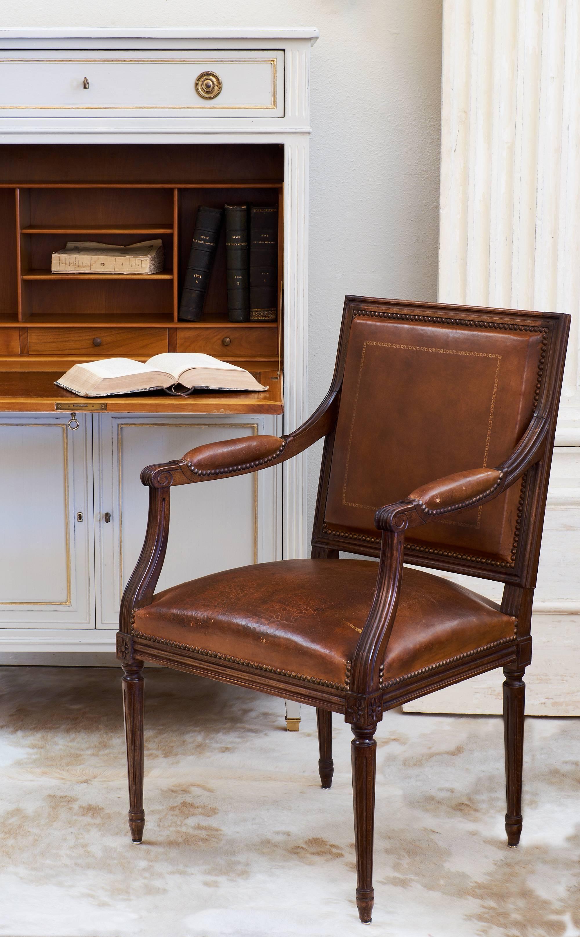 This stunning secrétaire is made of solid cherrywood with bronze feet and hardware and gold leaf details throughout. The drop front has an impeccable patinated leather writing surface. This wonderful storage piece has lots of dovetailed drawers. It