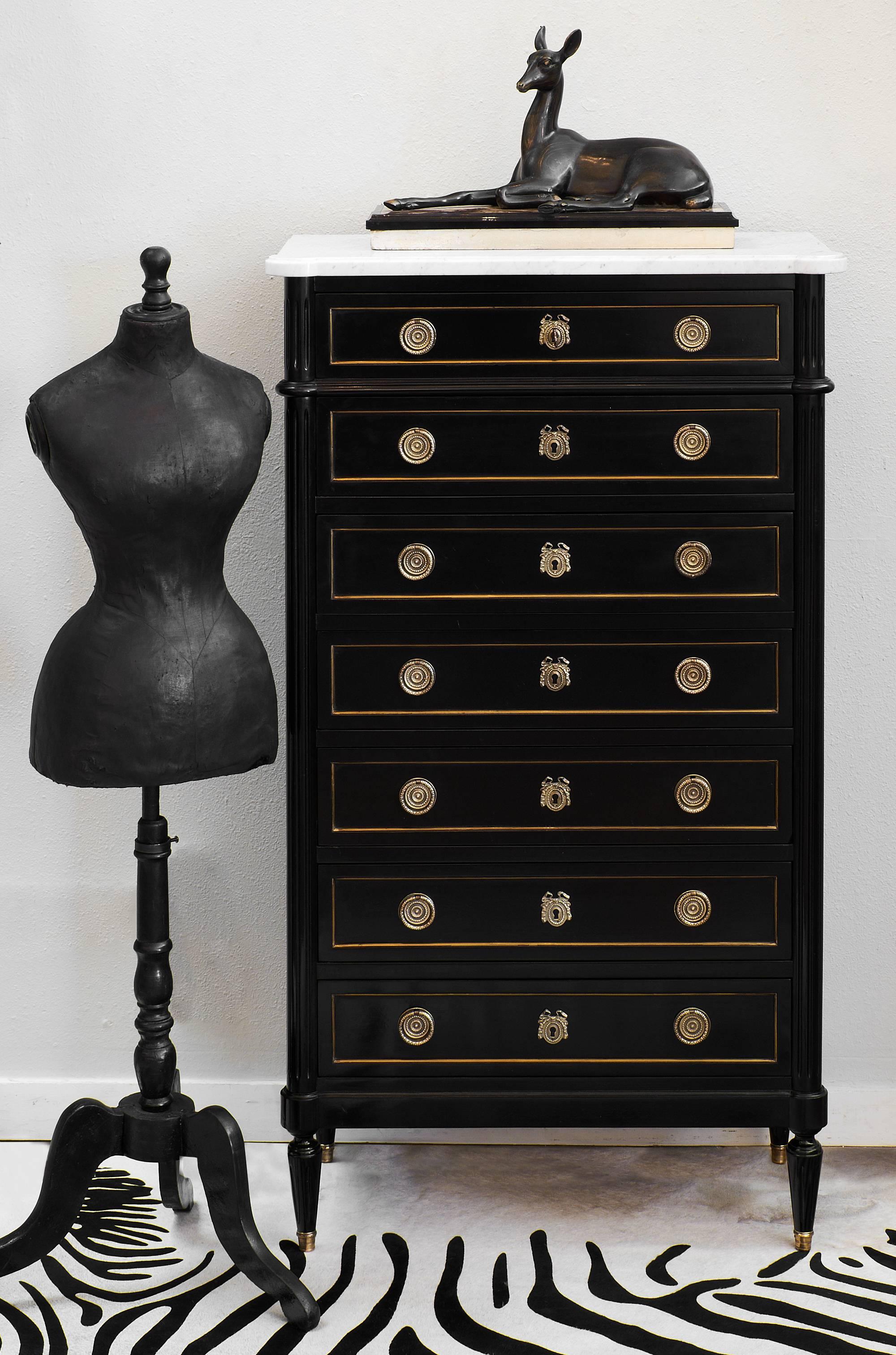 Mahogany Louis XVI style semainier from 1920. This piece is the epitome of chic! With seven drawers, a drawer per day of the week (La Semaine means week in French) this bold and sophisticated piece catches the eye. It has a lustrous French polish