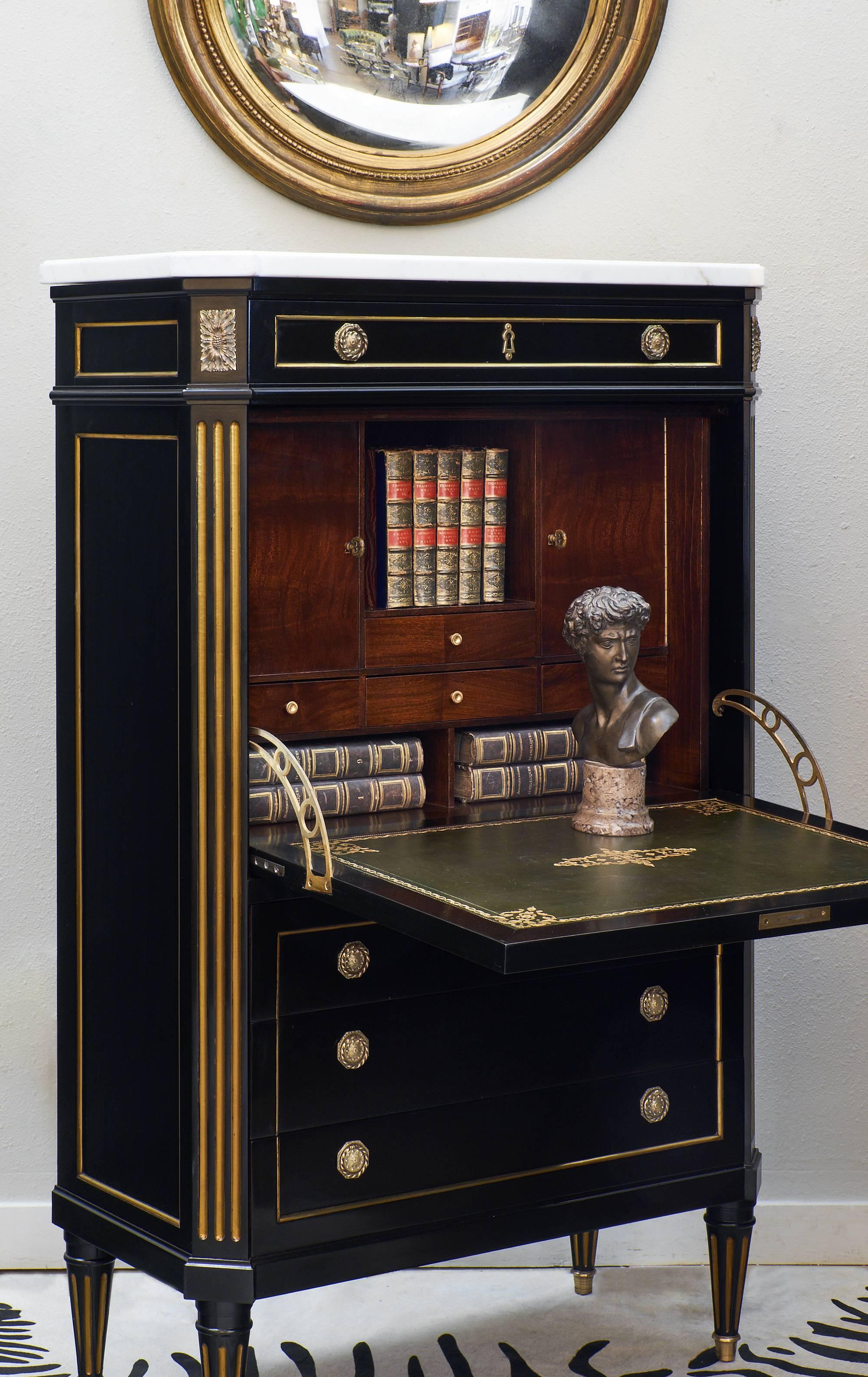 This is a wonderfully crafted piece! The ebonized and French polished wood has a high luster, museum quality finish. Topped with a thick Carrara marble slab in great condition, this secretaire also features gilt trims throughout. The secretaire has
