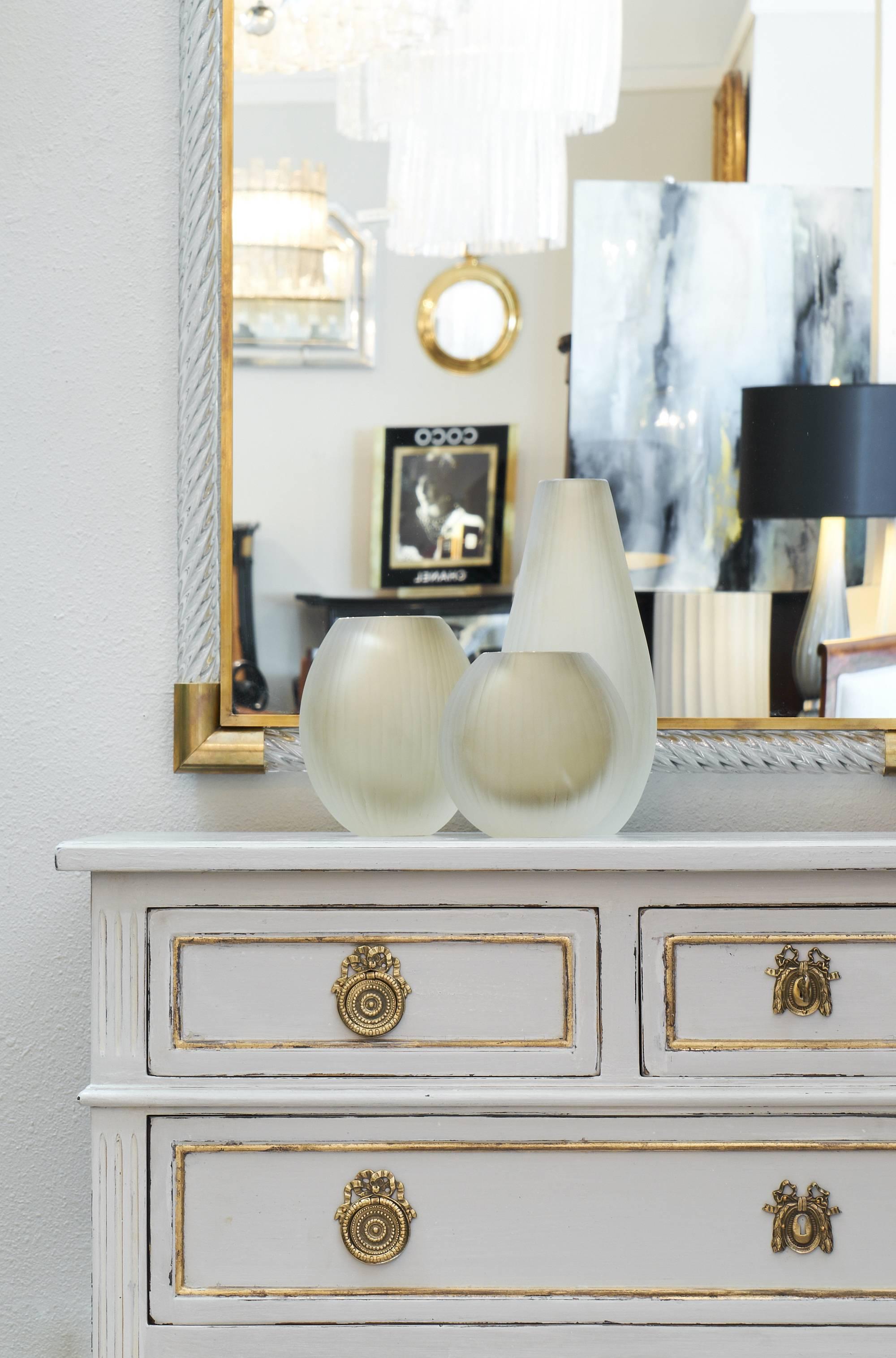 Finished with gold leafed accents on the trims, this hand-painted Directoire chest of drawers is of fantastic quality! The grey "trianon" color is beautiful, and contrasts wonderfully with the finely cast gilt bronze hardware. This piece