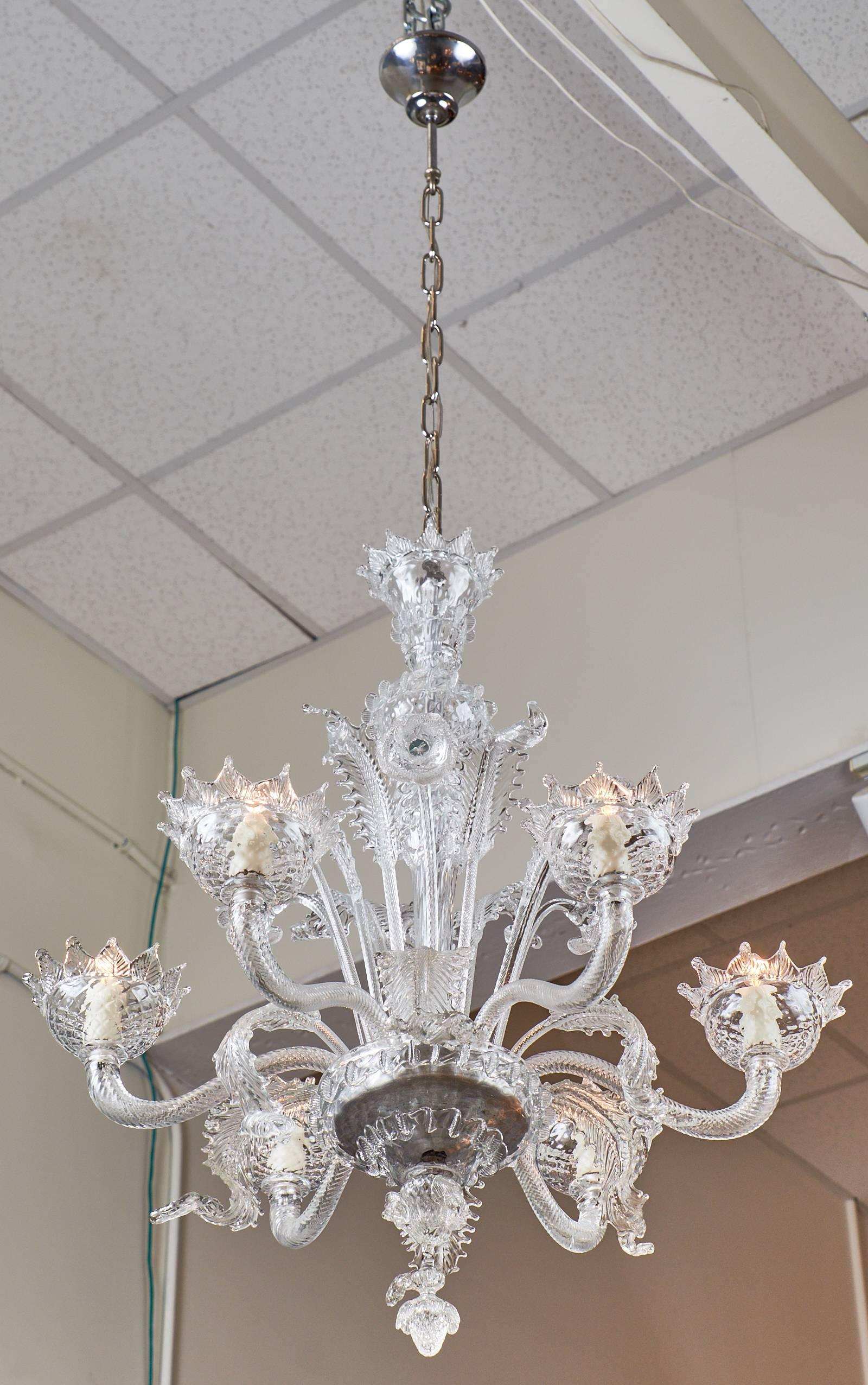 Stunning crystal clear handblown glass from the island of Murano at the beginning of the 20th century makes this wonderful Italian vintage chandelier so exquisite! This piece has intricate work on the leaves and main stem, as well as six torsado