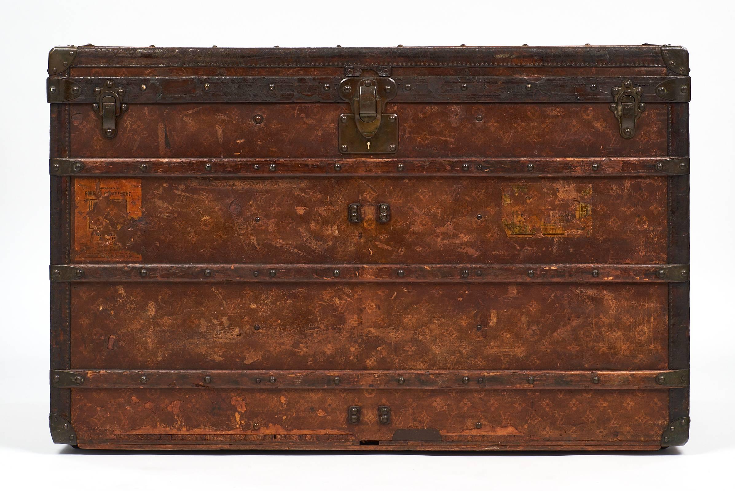 19th century steamer trunk by Louis Vuitton with stunning patina from age on the original leather canvas. This piece features Louis Vuitton monograms and 1st class shipping labels on the exterior, and wonderful details such as L.V. inscriptions on