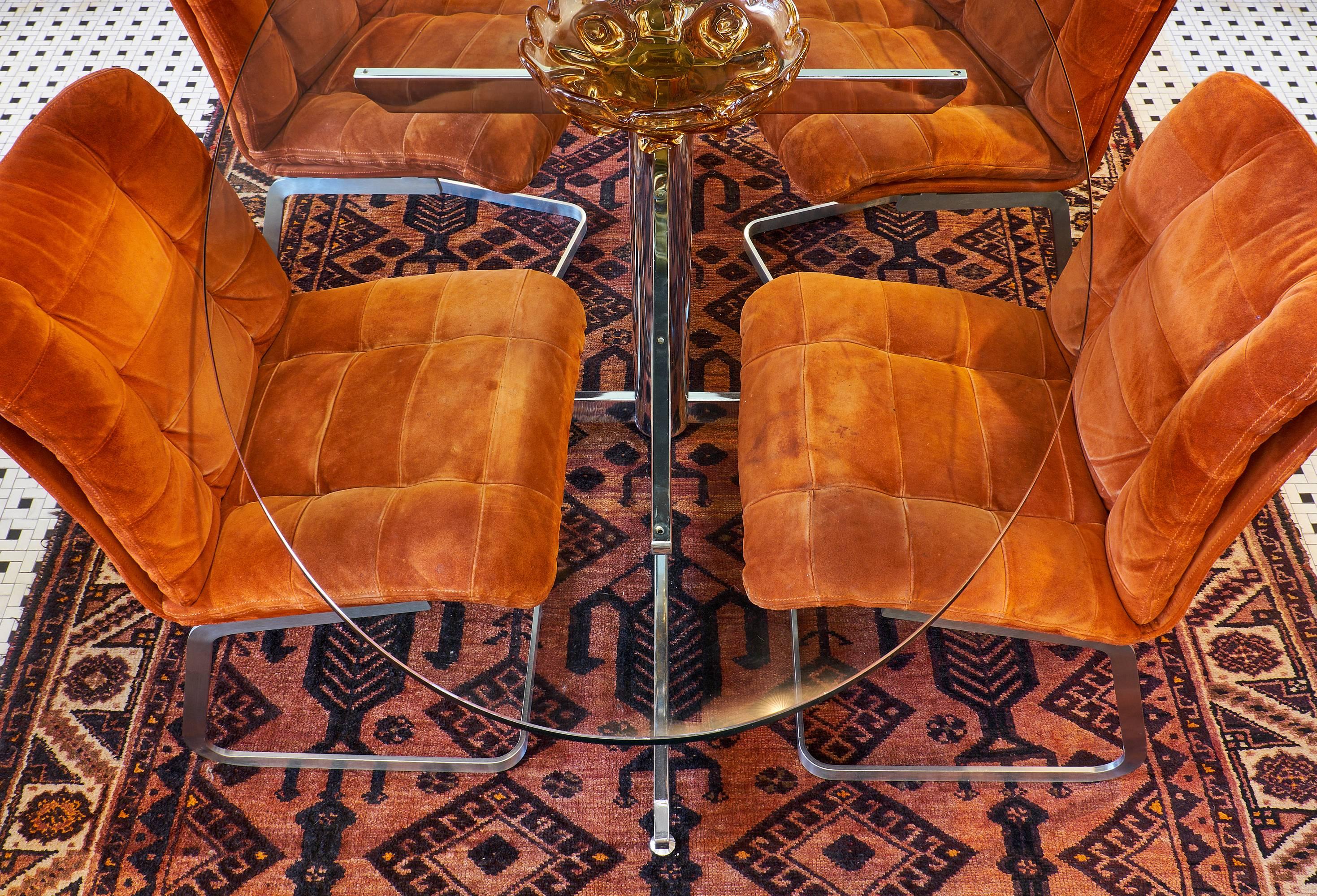 Rouche-Bobois set of six chairs, expertly upholstered in full suede and mounted on brushed steel bases. The original upholstery is in good vintage condition with minor fading and staining from age. This set is very comfortable and the color is