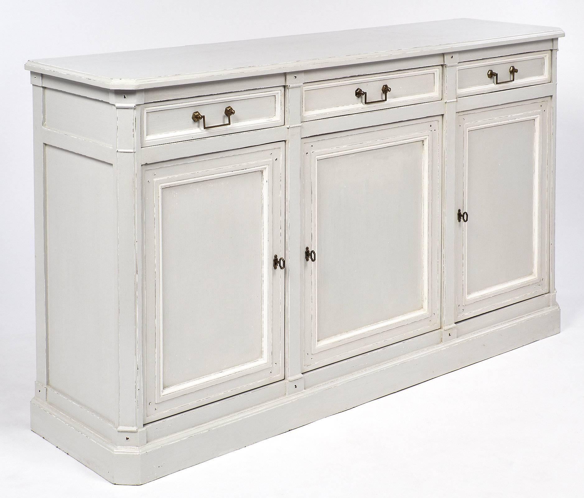 Wonderful buffet in the Louis Philippe style with three doors and three drawers. This piece has been painted with a grey Trianon color and features white trim and details. The piece has solid brass handles and the original locks and keys. This