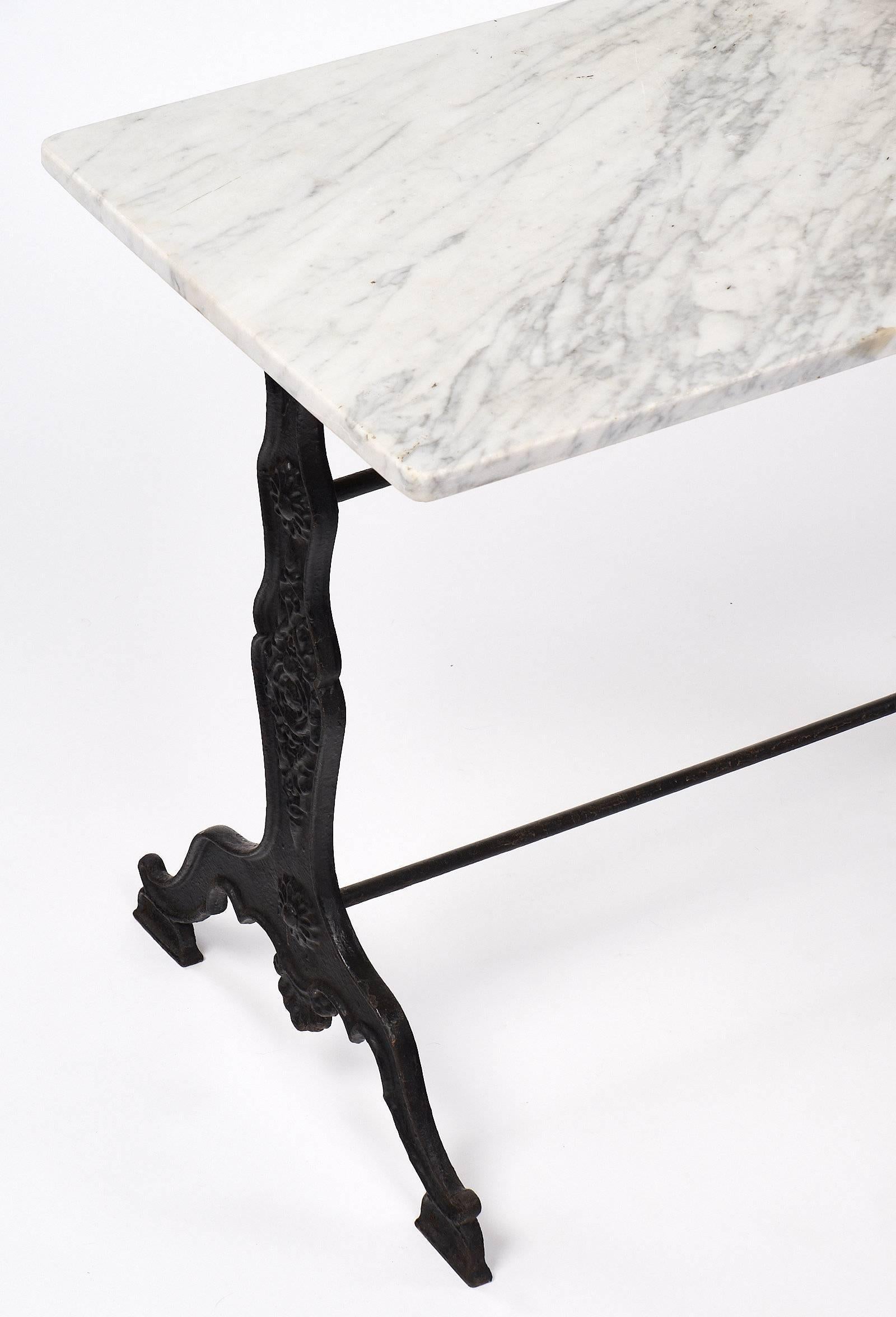 Antique French bistro table with the original Carrara marble top and a finely cast iron base. This piece brings charm to any space and is from Provence, France.
     