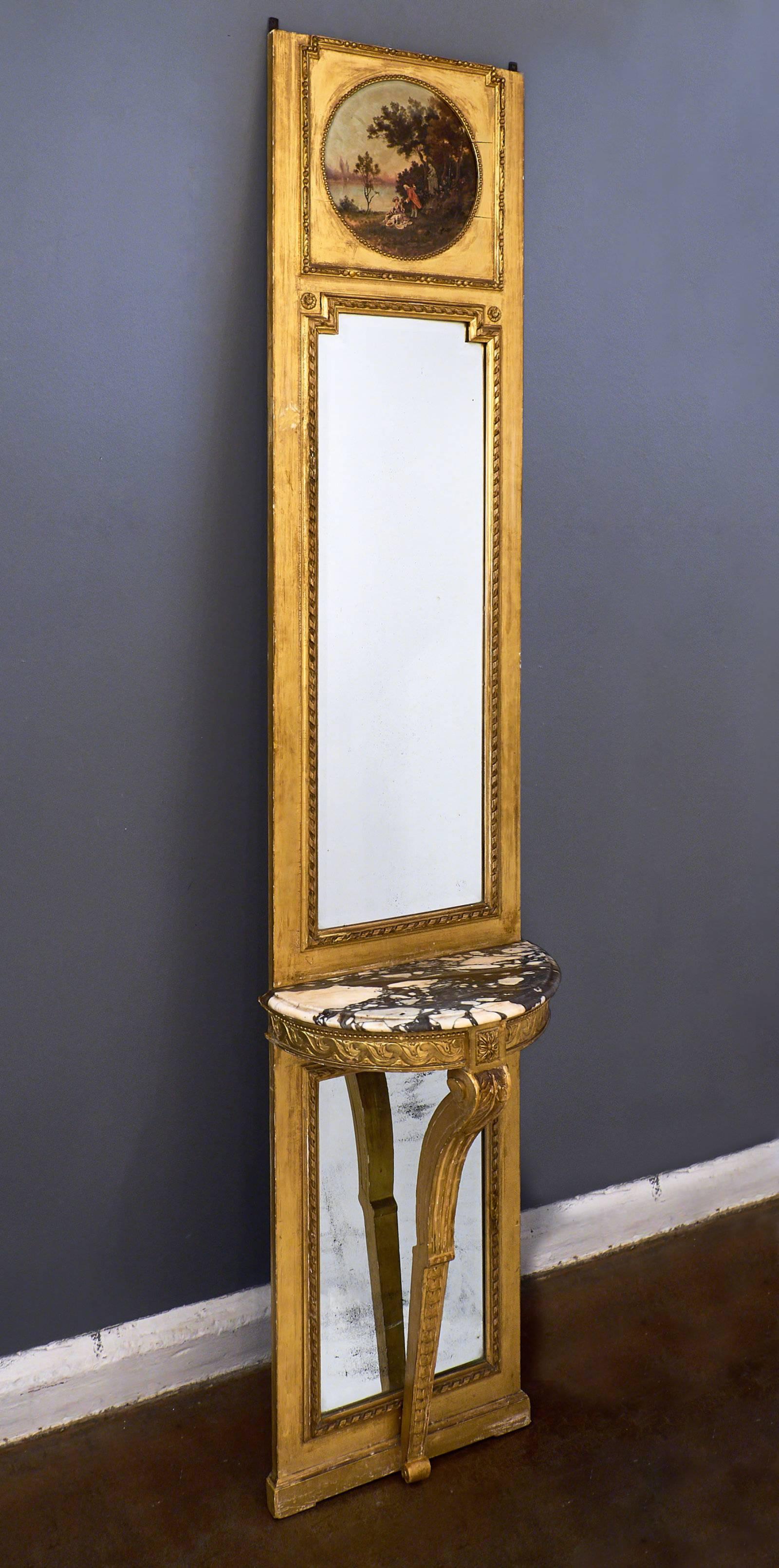 This very rare and important trumeau featuring a console style table in the Louis XVI style is hand-carved and includes neoclassical frieze details. The console table has a Brêche marble top with fantastic contrast in the veining. The mirrors are