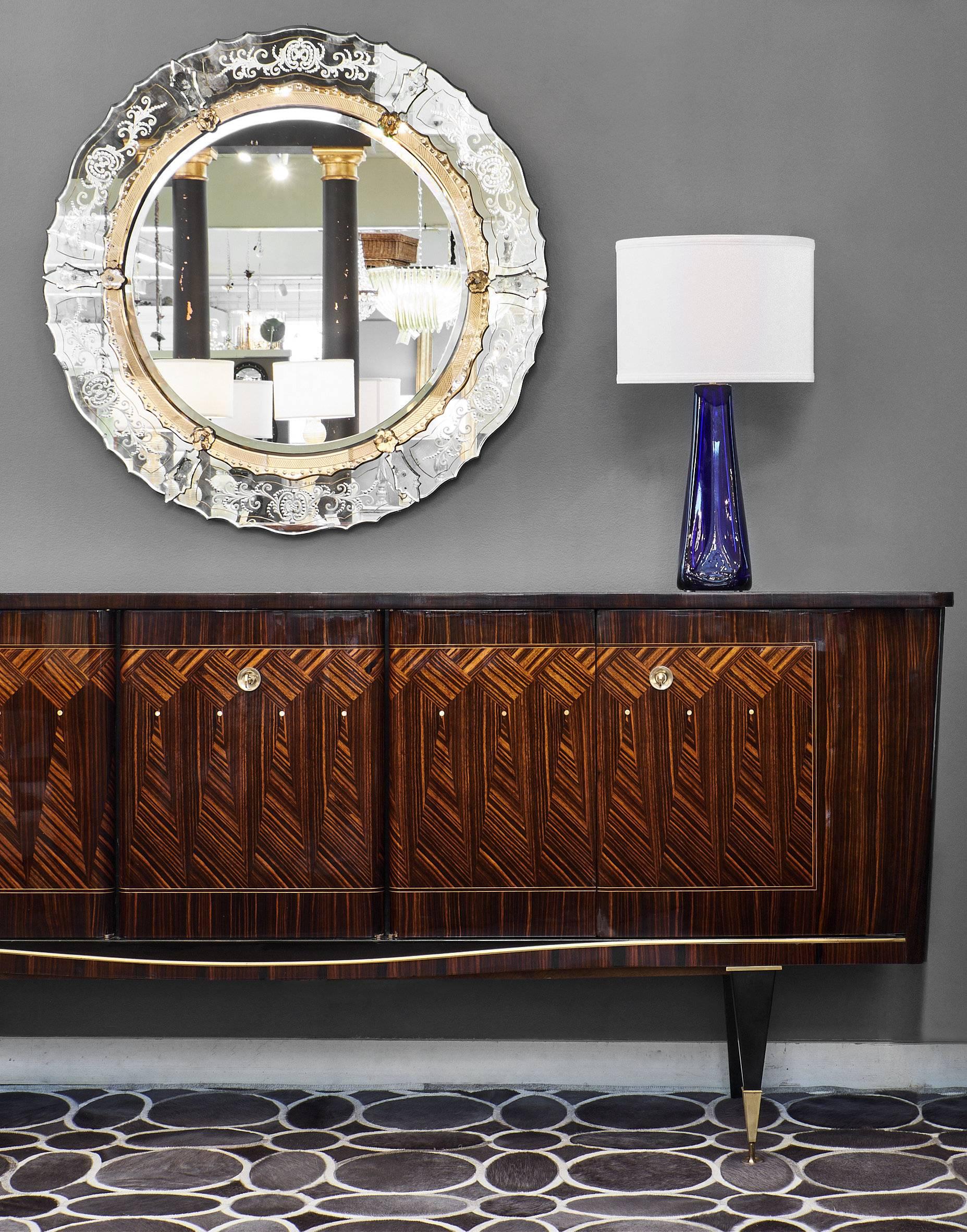 Impressive Mid-Century buffet from France made of Macassar of Ebony and inlaid with beautiful mother-of-pearl details. The facade of this buffet features geometric marquetry in a wonderful diamond pattern. The piece stands on tapered legs, and the