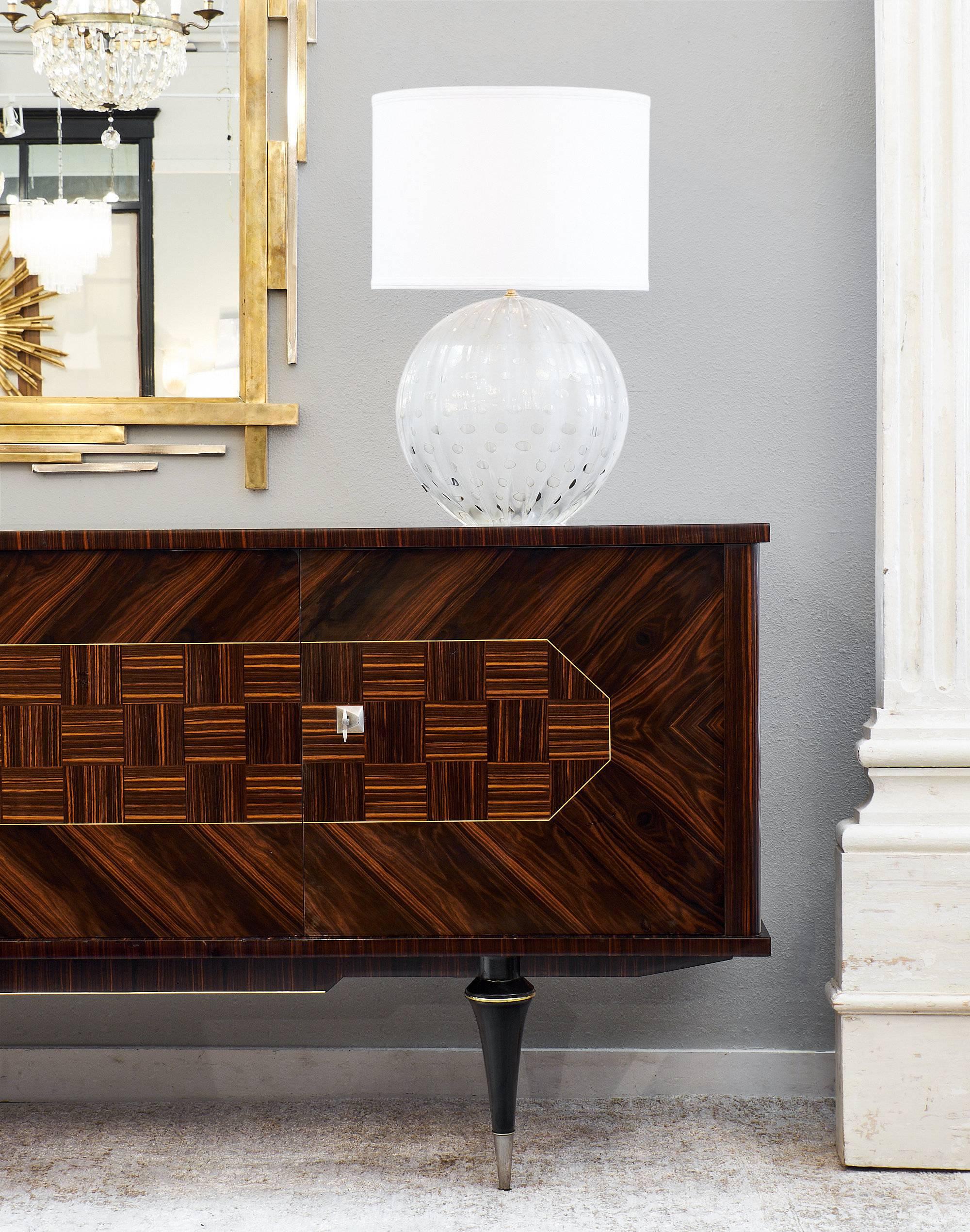 Incredible Macassar of ebony buffet with cubist marquetry across the front of the piece. The buffet has two sets of doors, each set with a brass lock and key in working order. The interior is made of satinwood. On the right side of the buffet, the