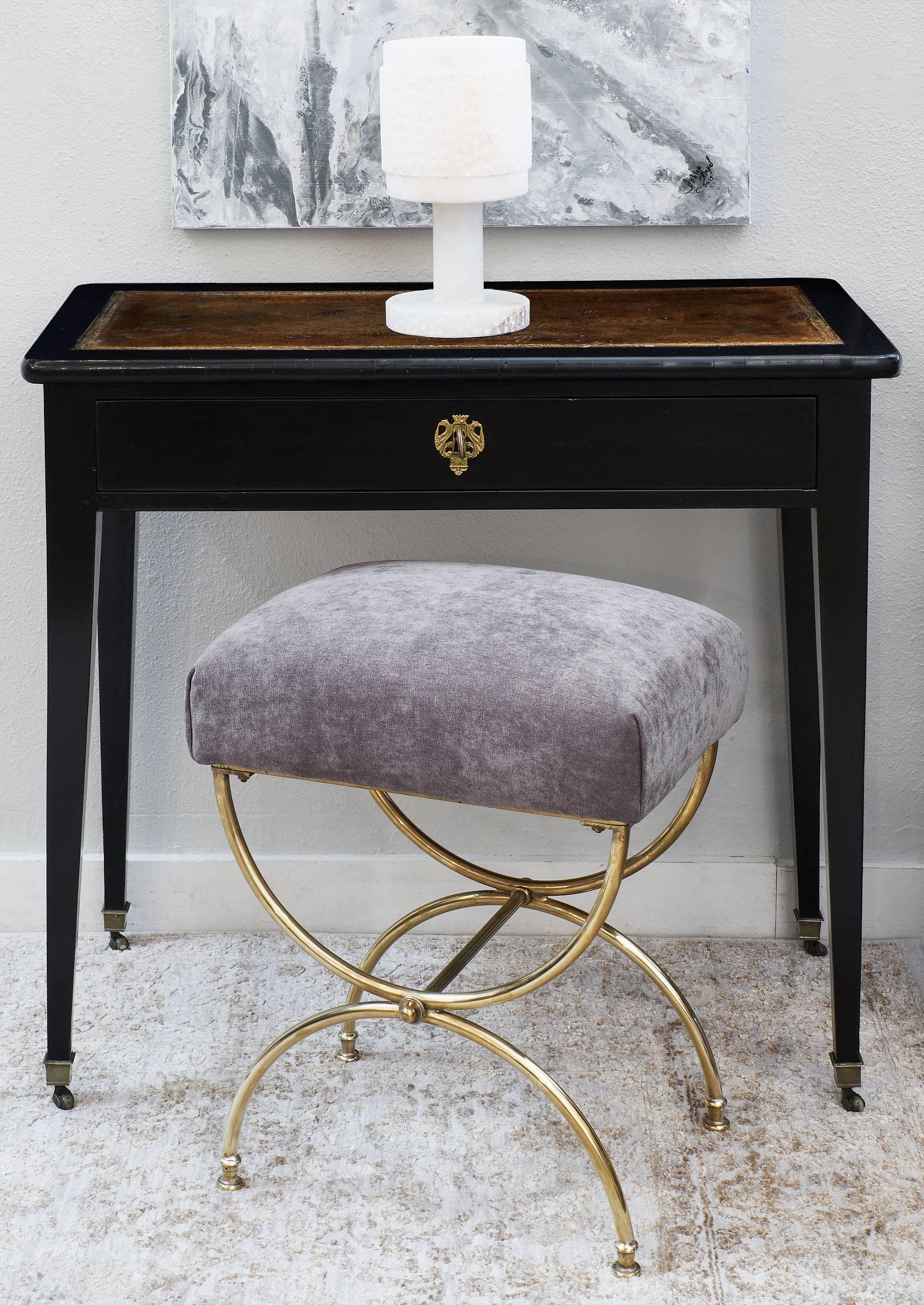 This Louis XVI style writing table or console is the perfect size for an entryway or small home office! The mahogany piece has been ebonized and finished with a French polish for a lustrous glow. The table has one dovetailed drawer with original