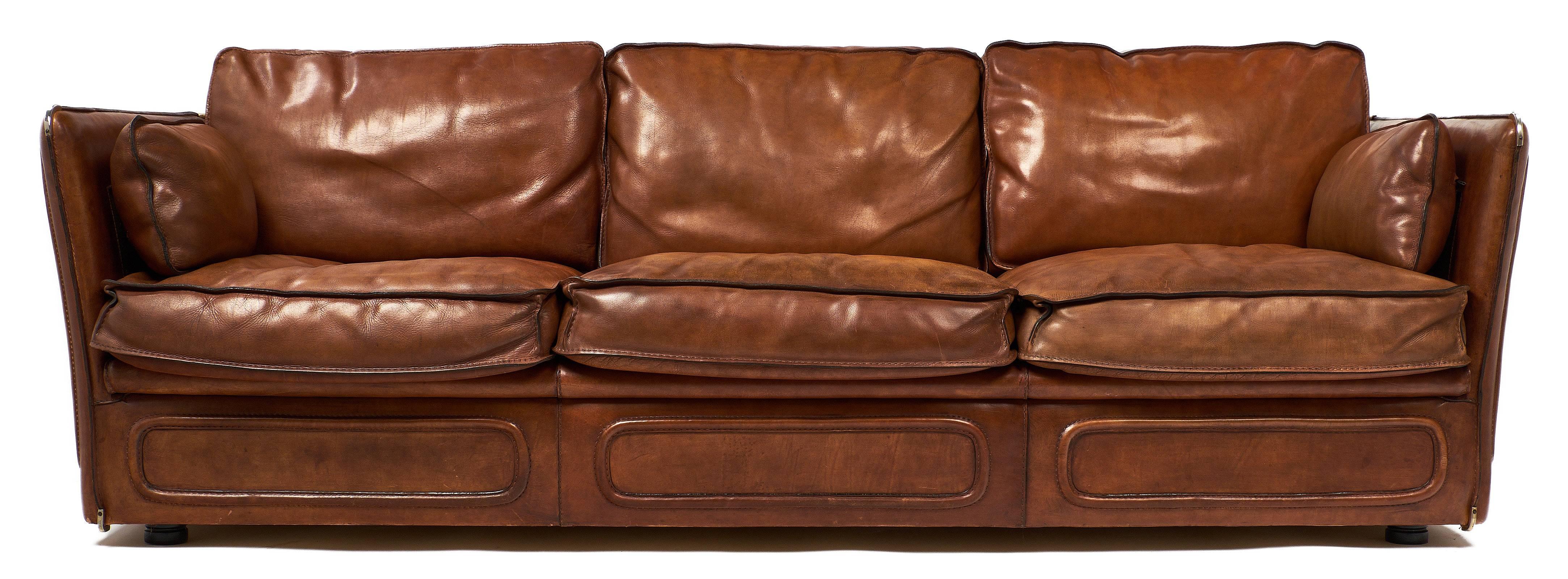 Fantastic vintage French sofa made completely of full buffalo hide leather in a warm cognac color. This piece features stunning equestrian saddlery style stitching on the sides, back, and below the seat on the front. These details are quite gorgeous