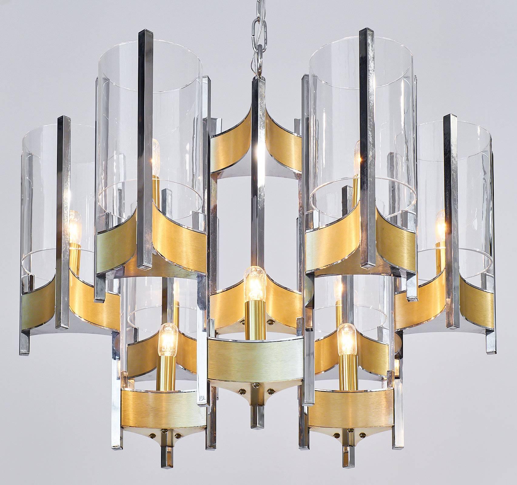 Acquired in Lyon, the south of France, this stunning chandelier is in the Structuralist manner, known more commonly in the US as Postmodern. Made of brass and chrome in geometric, spatial configurations create beauty while also functionally