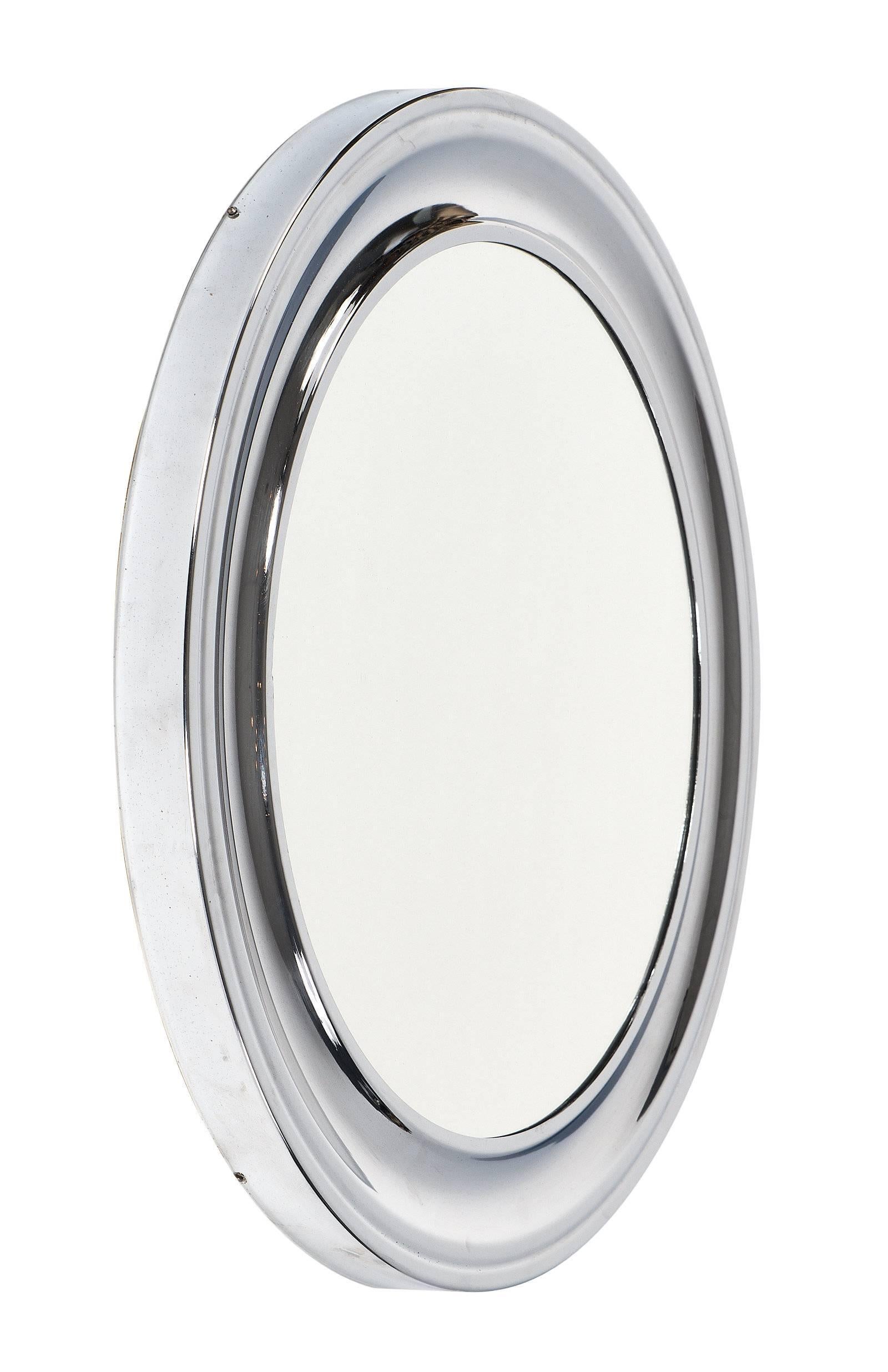 Circular mirror with a polished chrome frame. The original mirror in the center is in excellent condition, and the frame has a concave center that creates depth and texture. This simple mirror is quite striking and modern!