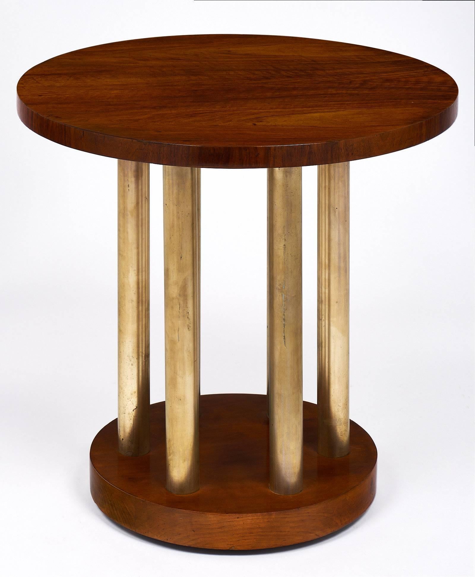 A bold and elegant gueridon with a solid walnut base and top. The piece boasts six tubular brass legs with a striking patina. We loved the strong feel of the piece and the contrast between the beautiful French polish glow on the walnut and the light