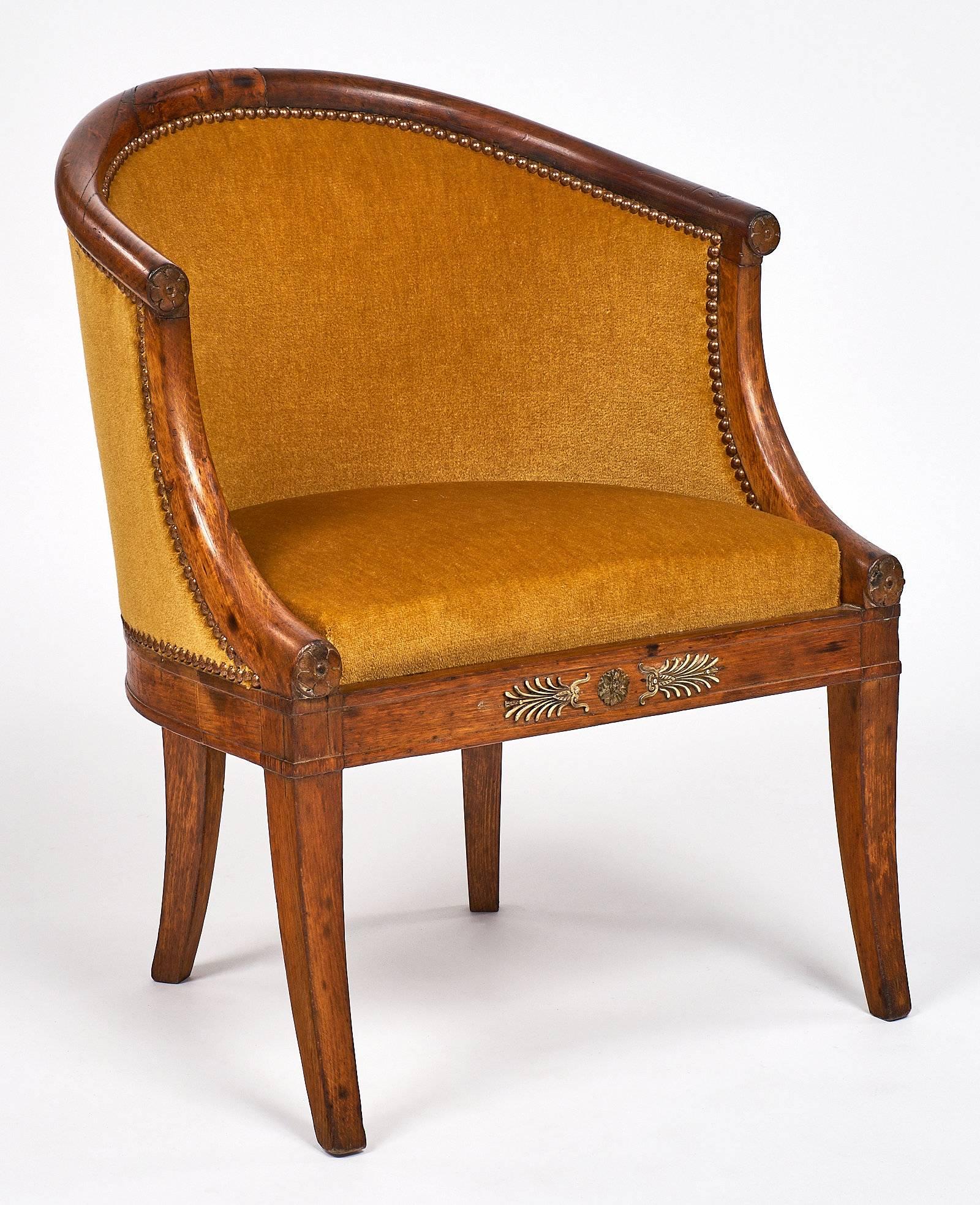 Early 19th century French antique set of chairs with the original golden colored velvet upholstery. This set of four has the beautiful curved barrel backs that started in the Charles X period. The wood frames are finished with a French polish for