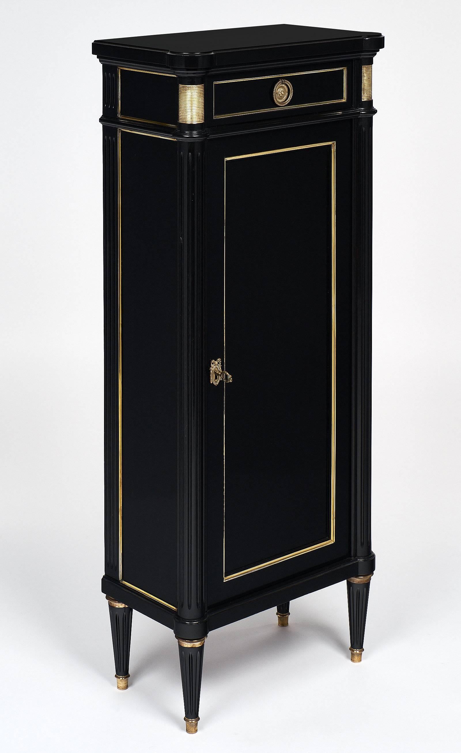 Elegant Louis XVI style cabinet made of mahogany that has been ebonized and finished with a French polish. This superb piece has wonderful proportions and a great size. The piece has brass trim and bronze hardware. One dove tailed drawer is located