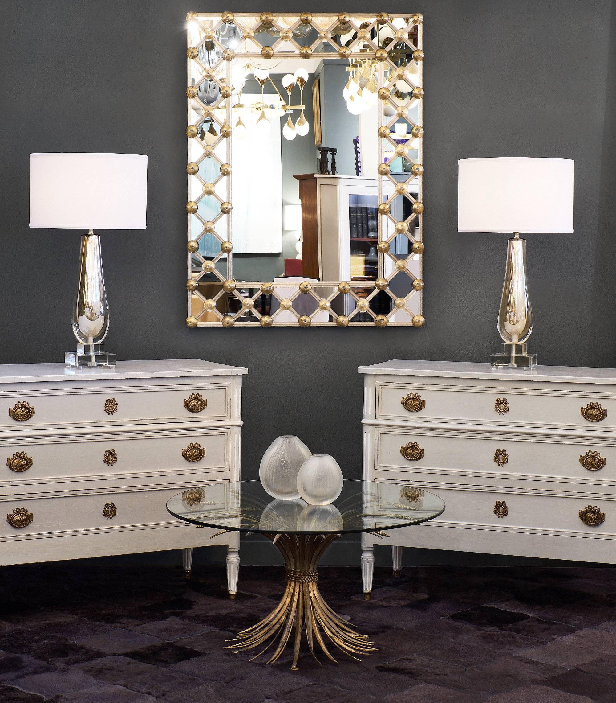 Pair of unique painted chests from the 19th century in the Louis XVI style made of mahogany. These chests feature hardware made of finely cast brass and have been painted with a dove grey milk paint. The legs that support each chest are tapered and