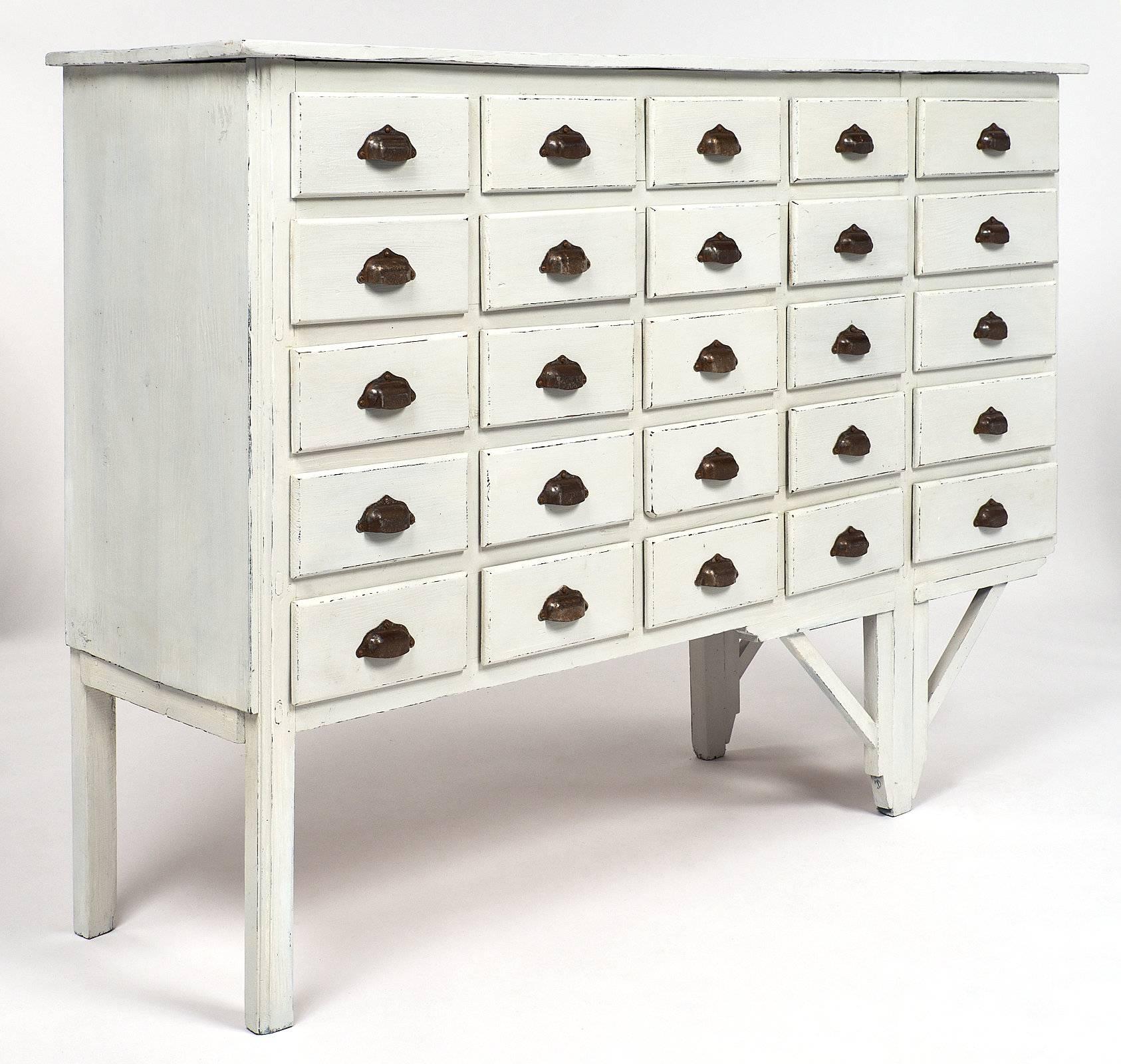 Unique and authentic antique Haberdashery cabinet from a late 19th century “Mercerie” in Lyon, France. This piece has an asymmetrical construction, probably due to the constraint of the work place, which gives it character and an interesting