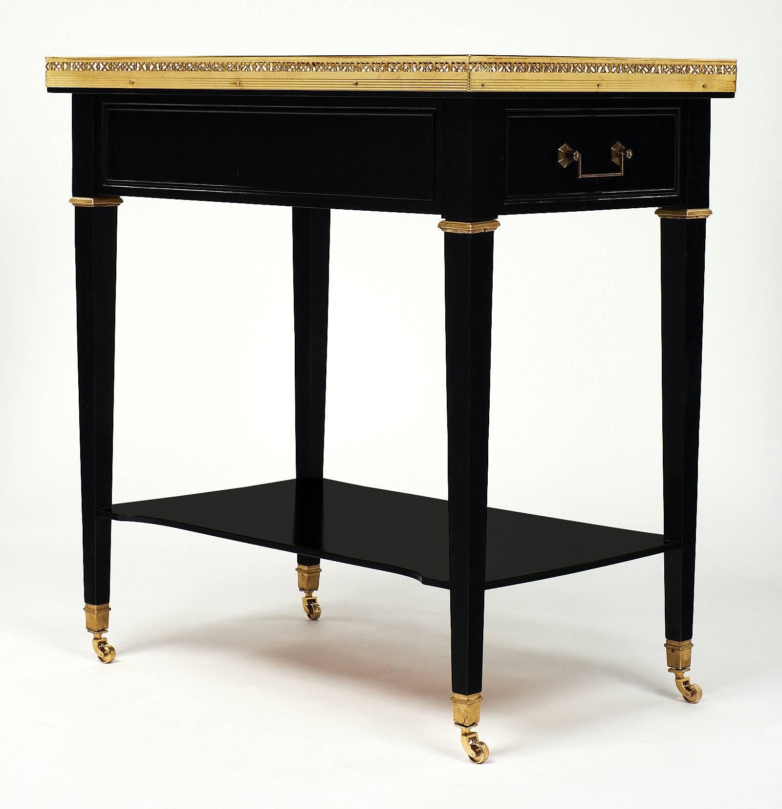 Excellent Louis XVI style rafraichissoir featuring brass champagne buckets and a marble surface for functionality as a bar while entertaining! This piece is made of mahogany that has been ebonized and finished with a French polish for luster. It is