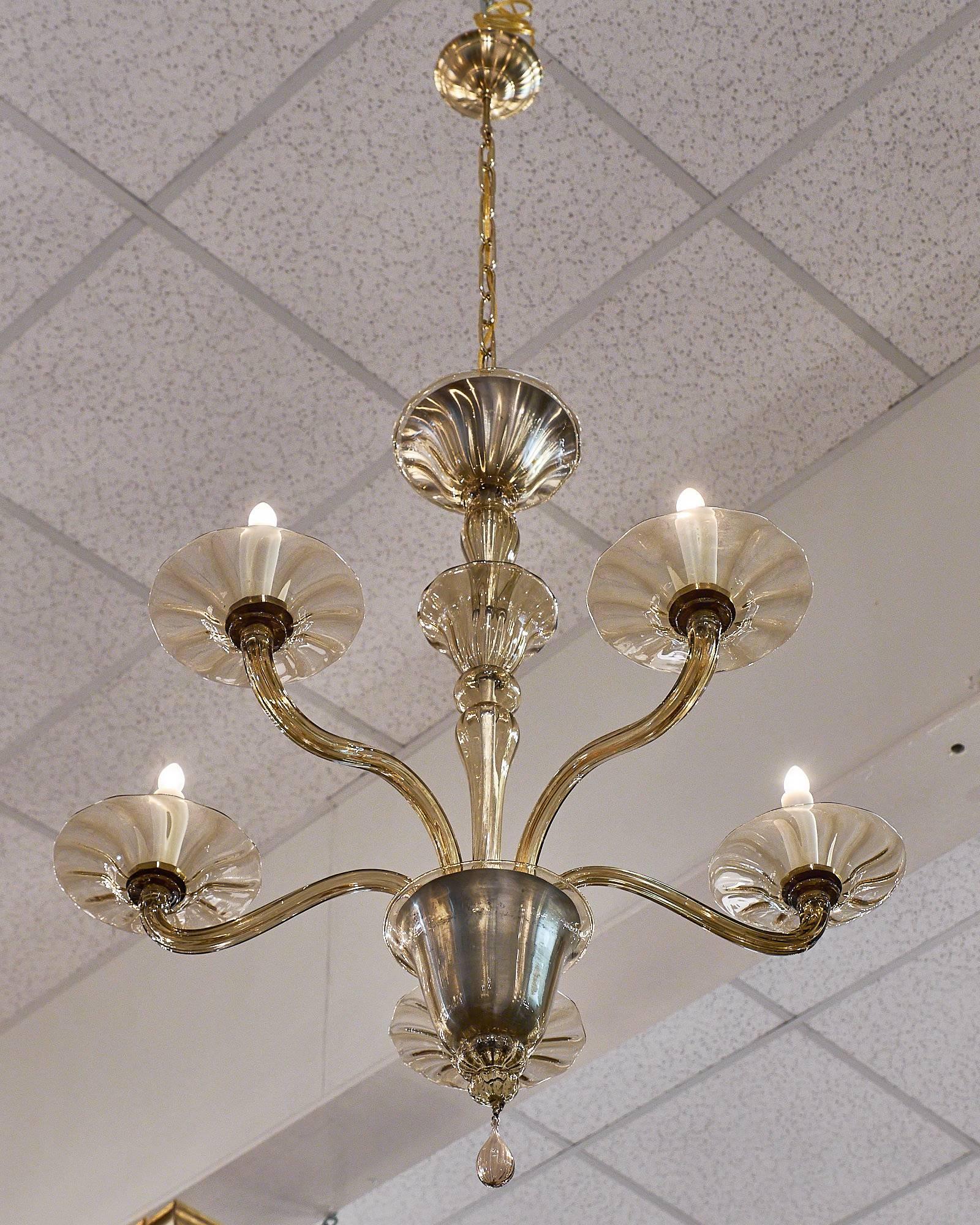 Beautiful vintage Murano glass chandelier with five arms. This traditionally shaped, hand-blown piece has a lovely translucent amber color to the glass and flared “bobêches.” We love the small size and simple forms. It is a beautiful fixture, wired