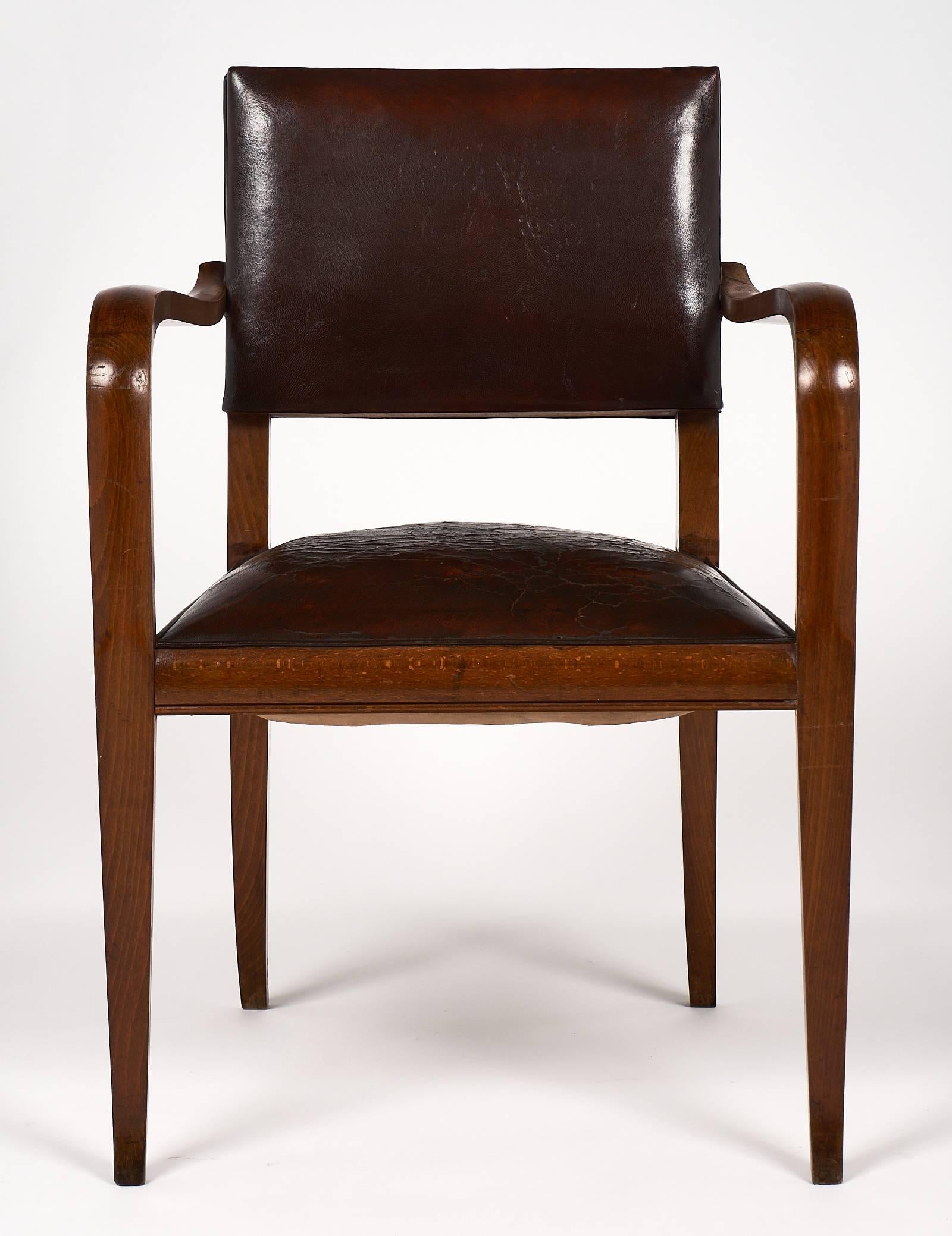 Wonderful French Art Deco period armchair in solid walnut with original leather upholstery. Leather and wood are in good condition. The chair is very strong and comfortable.