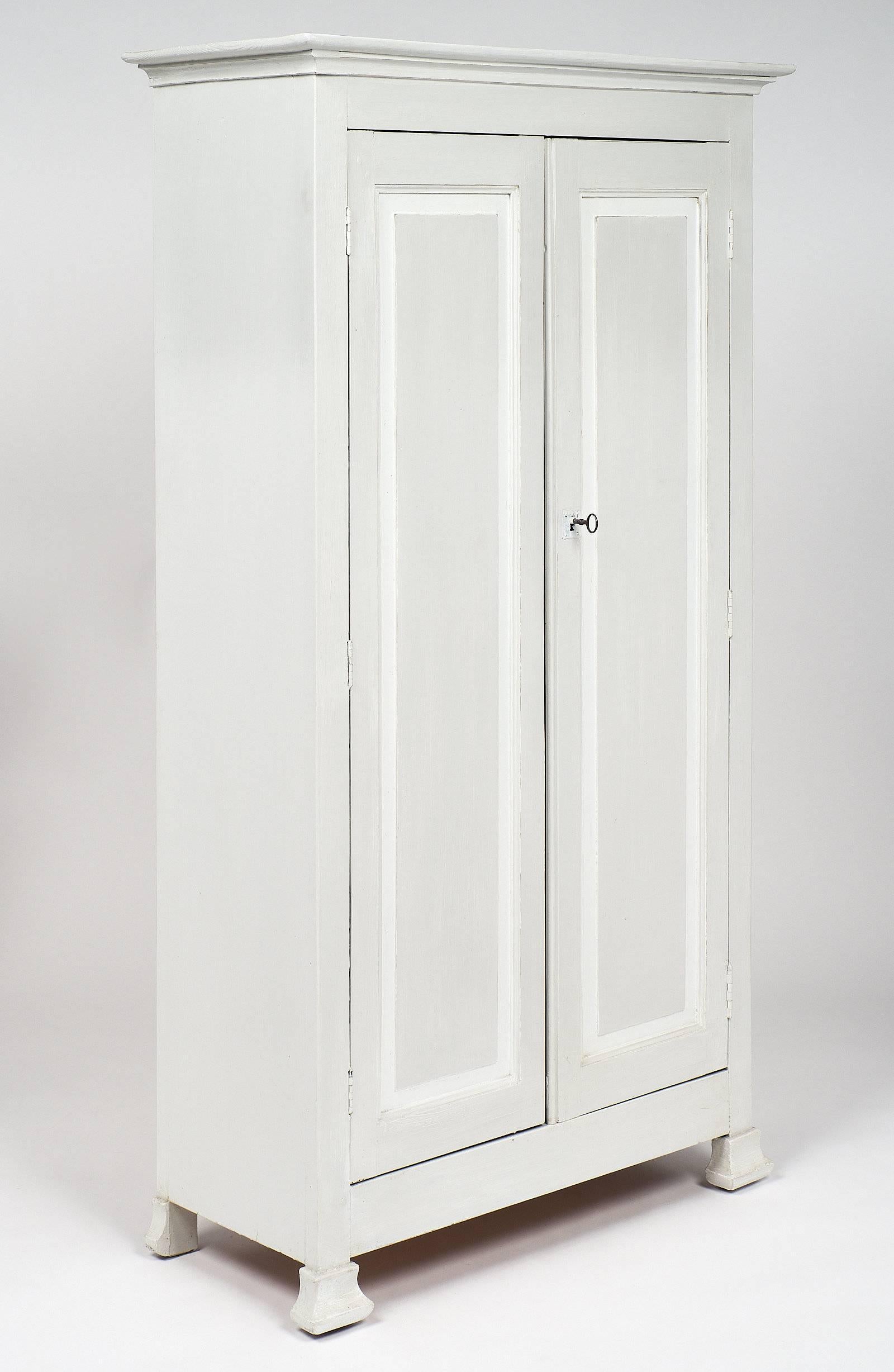 Classic armoire from the middle of the 19th century in France. This piece has a strong, impressive appearance with great lines and proportions of the Louis Philippe period. It stands on four feet and has trim around the top for detail. Two doors