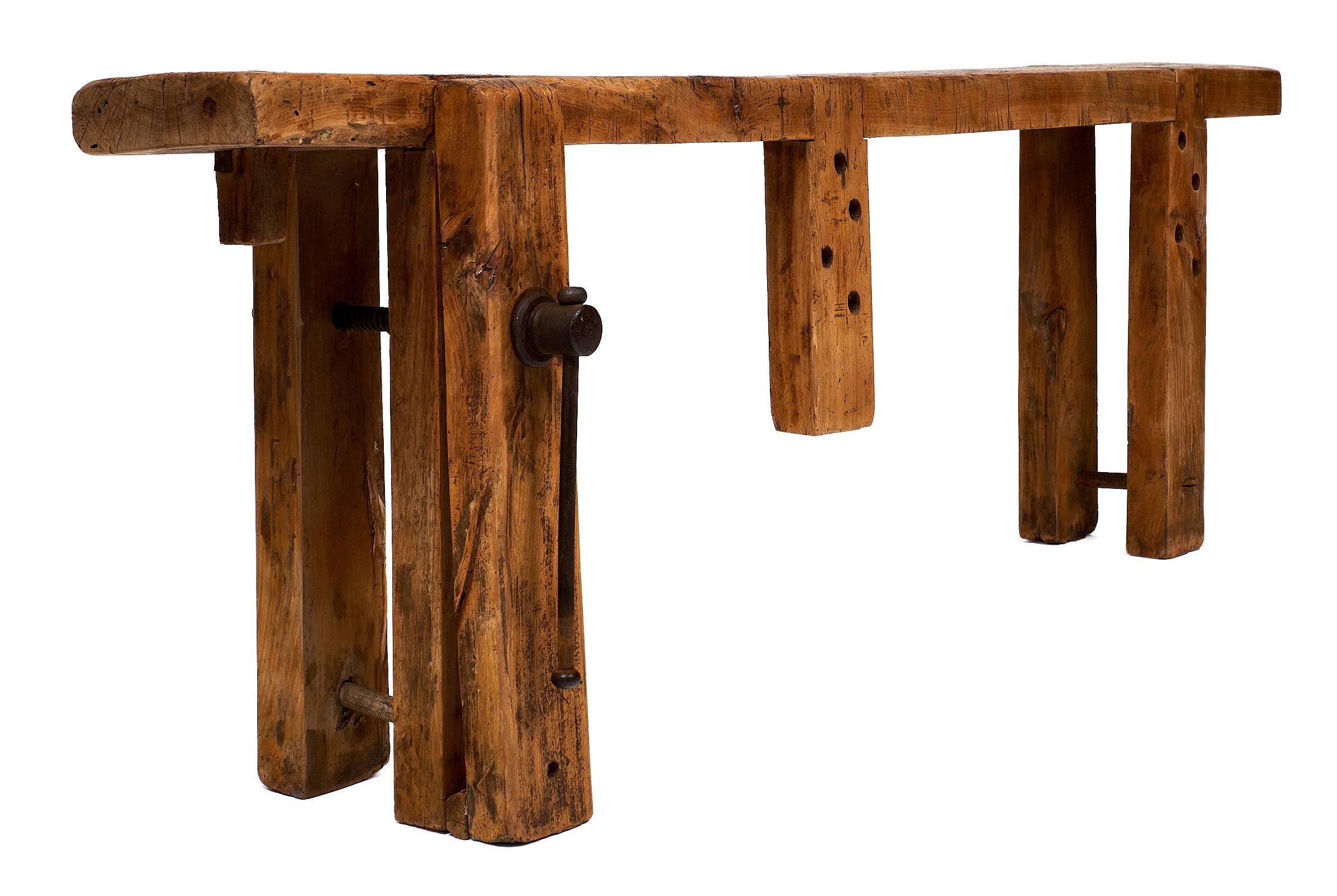 French antique, authentic 19th century workbench of chestnut wood with a traditional construction used by French craftsmen in the Rhone valley for the construction of furniture. The piece features a thick slab of wood on four strong legs and its