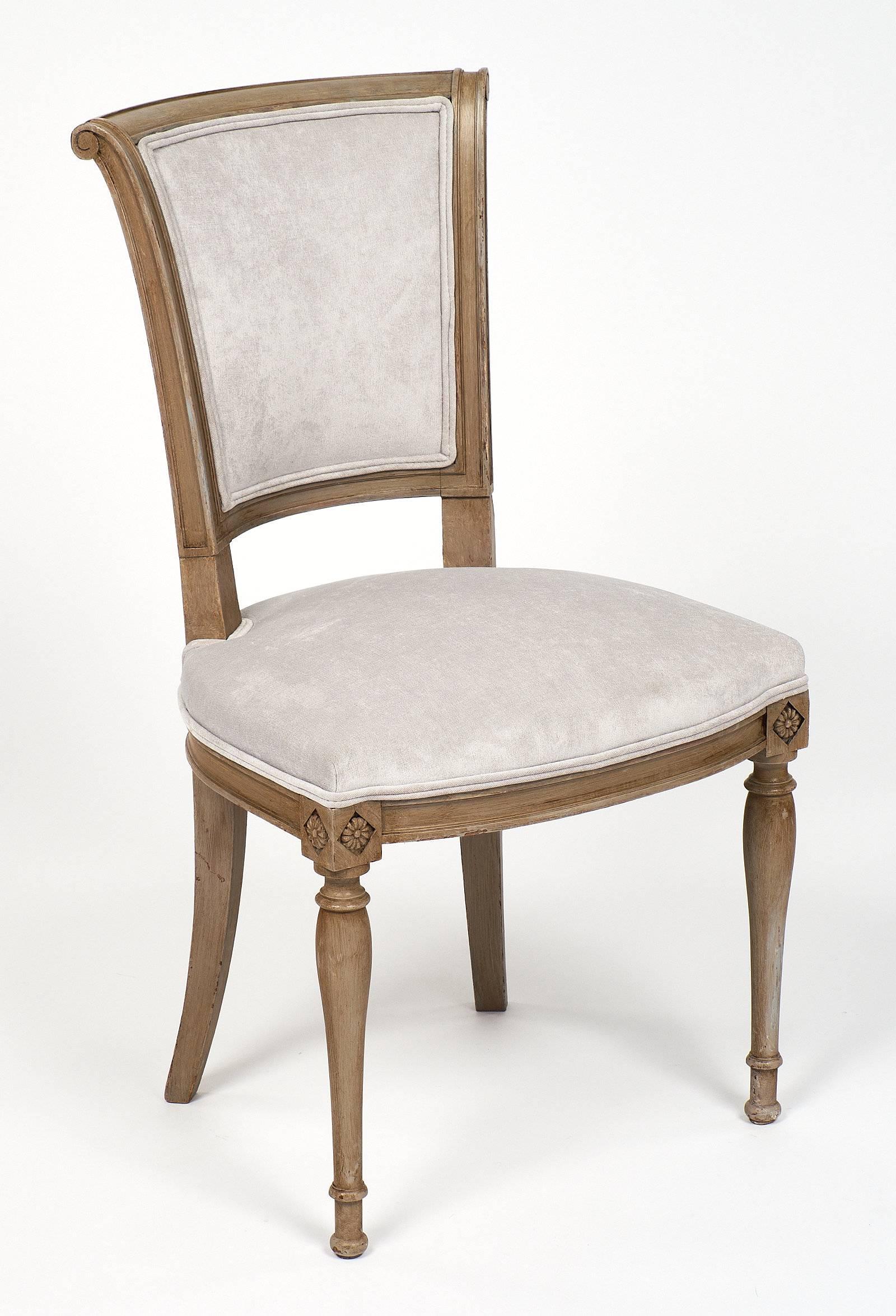 Set of six French directoire beechwood chairs, strong and elegant with a new velvet blend upholstery in a dove grey color. We loved the comfortable curved back, the classic pegs construction, and the overall perfect balance of the chair. The paint
