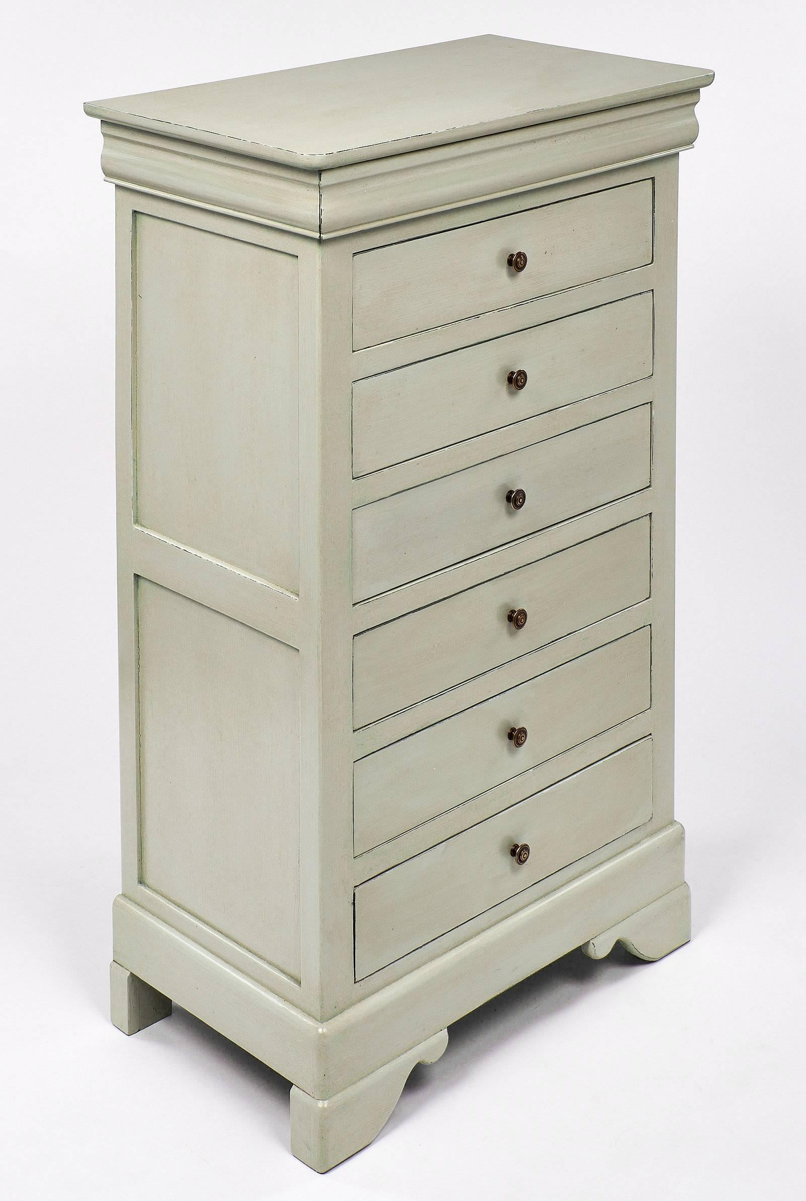 Louis Philippe semainier made of solid walnut, hand painted and patinated light green. This piece has six large dovetailed drawers. These are topped with a hidden drawer, a classical “doucine