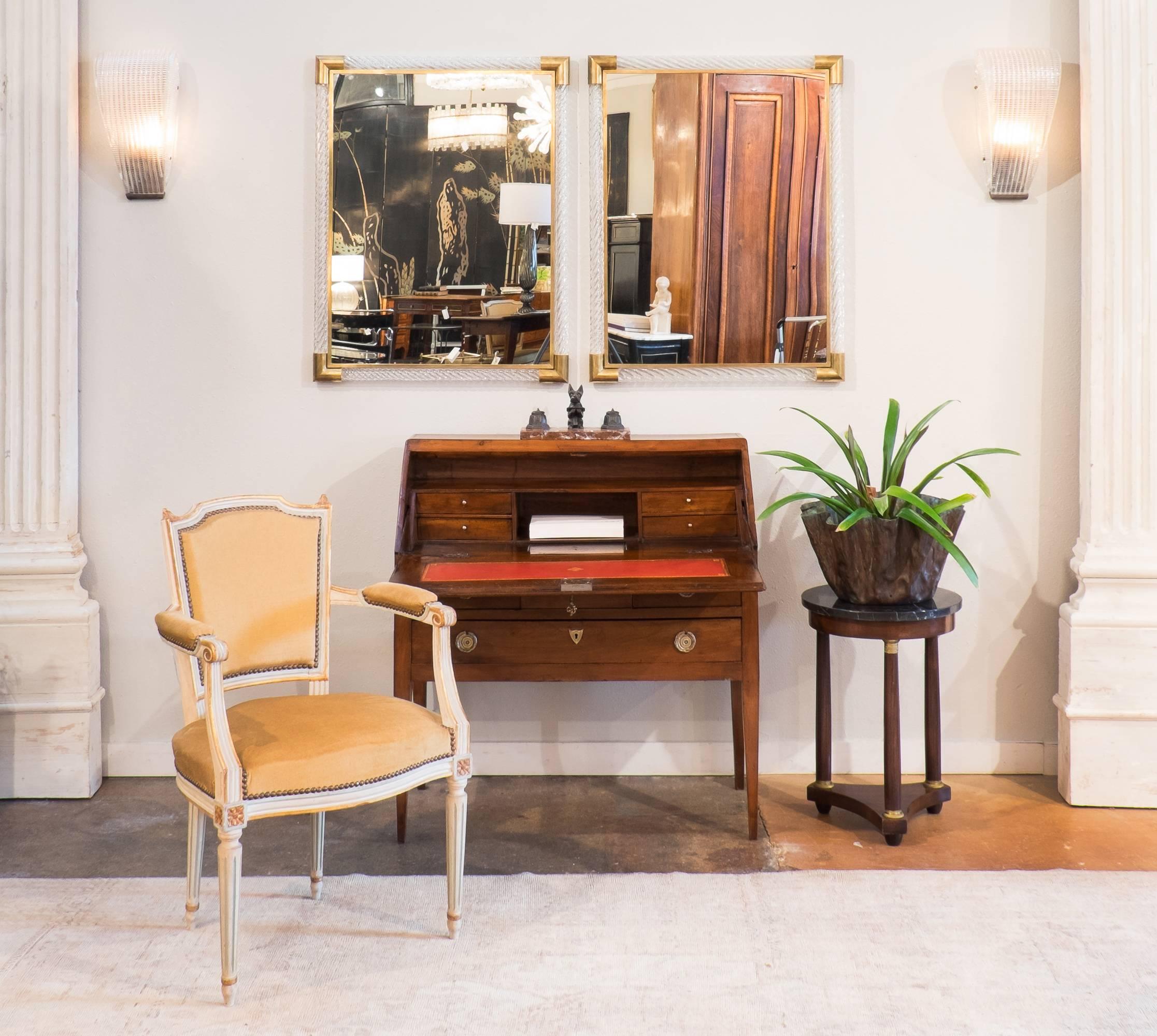 French antique Louis XVI period drop front desk of solid cherrywood. With a secret compartment inside and its red leather writing surface with an embossed gold leaf frieze. We picked this one at an Auction in Beaune in the middle of the Burgundy