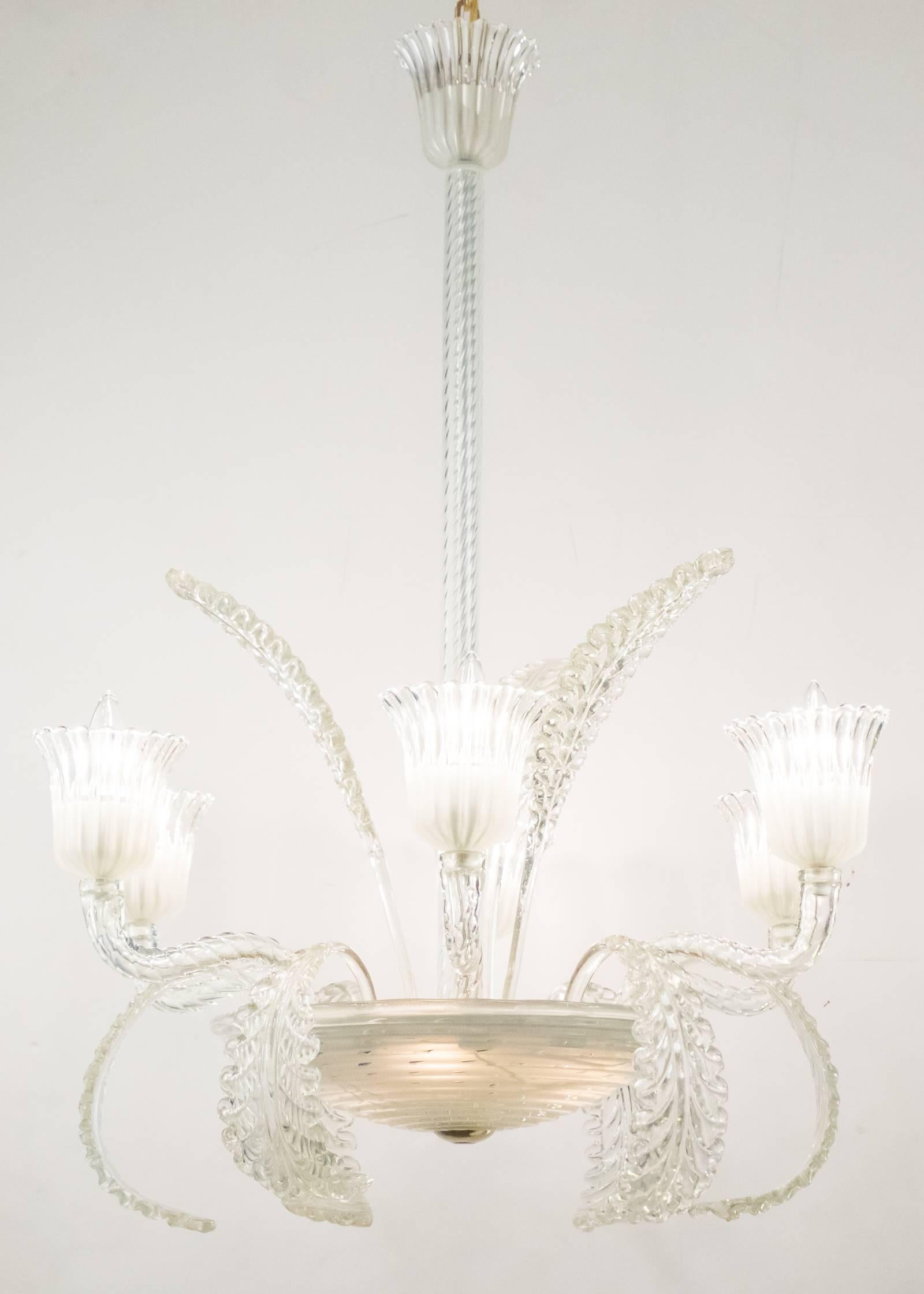 Italian Art Deco handblown Murano glass chandelier with six branches and nine curling leaves flowing from a central cup. Holds a total of nine candelabra base bulbs, rewired for the US. Height with included brass chain and canopy is 56 in.