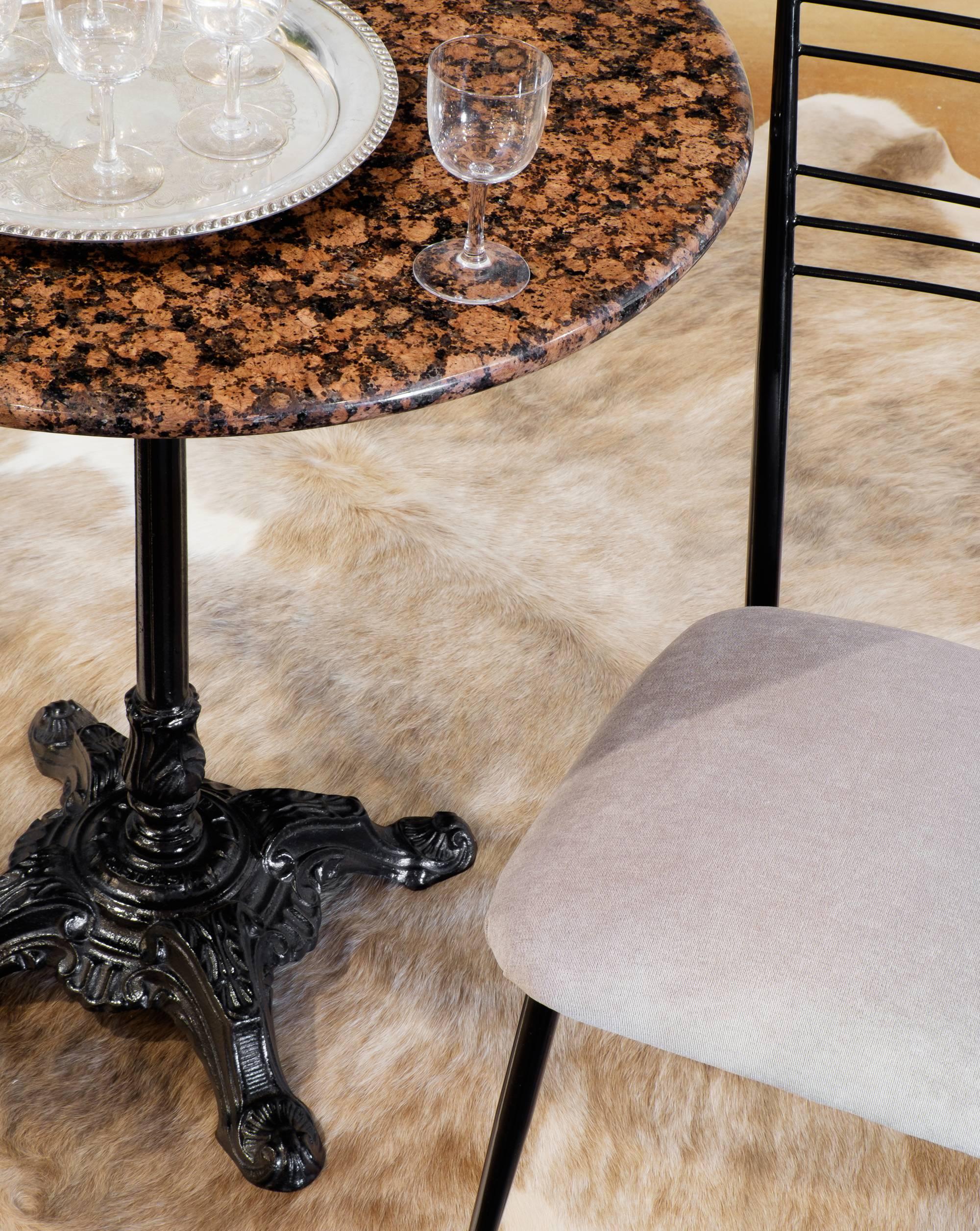 French vintage bistro table in cast iron with a polished marble top. A perfect perch for sipping espresso or wine, dreaming of the French Riviera.