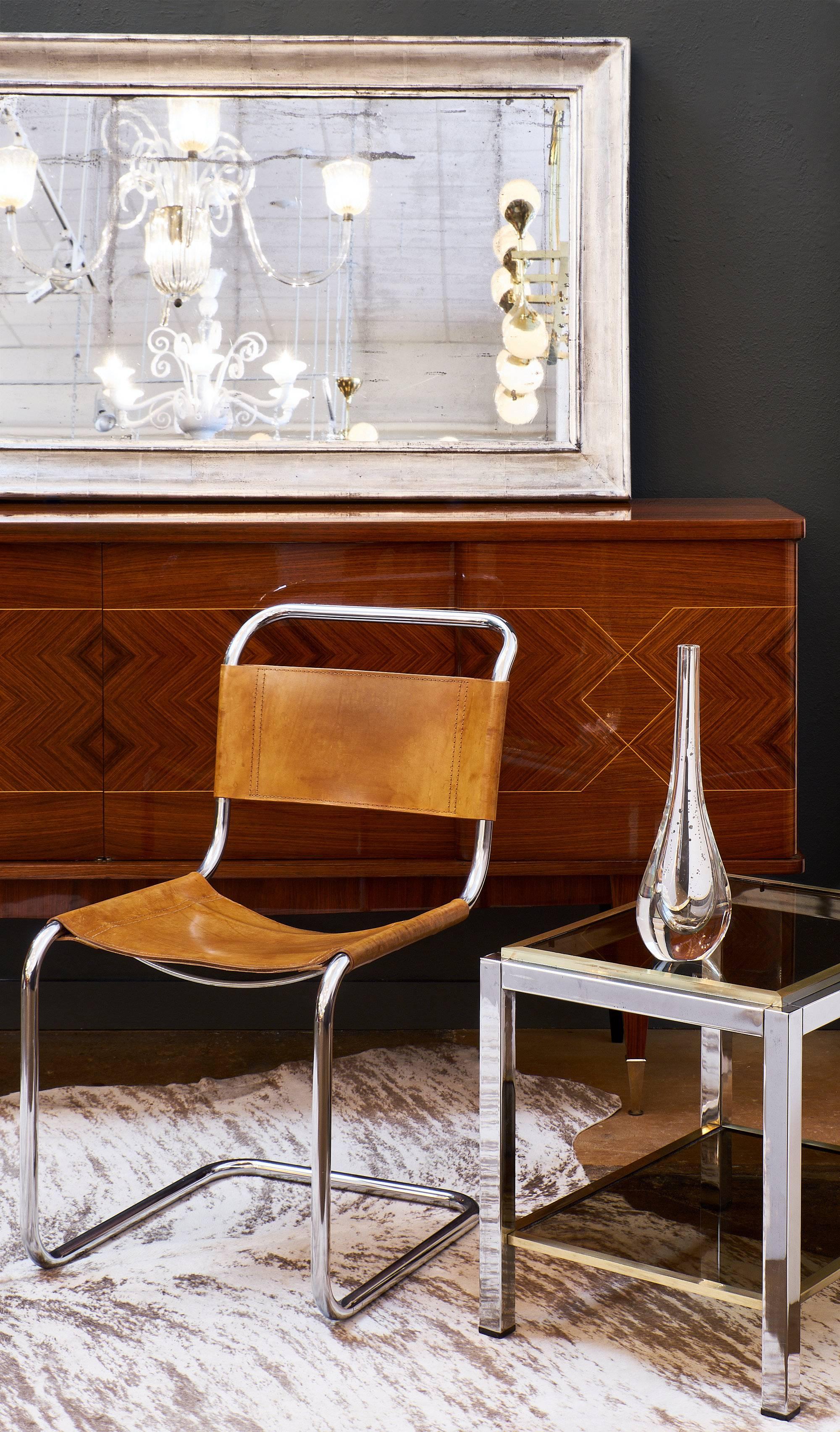 French Modernist vintage side table in polished chrome and brass with two smoked glass shelves.