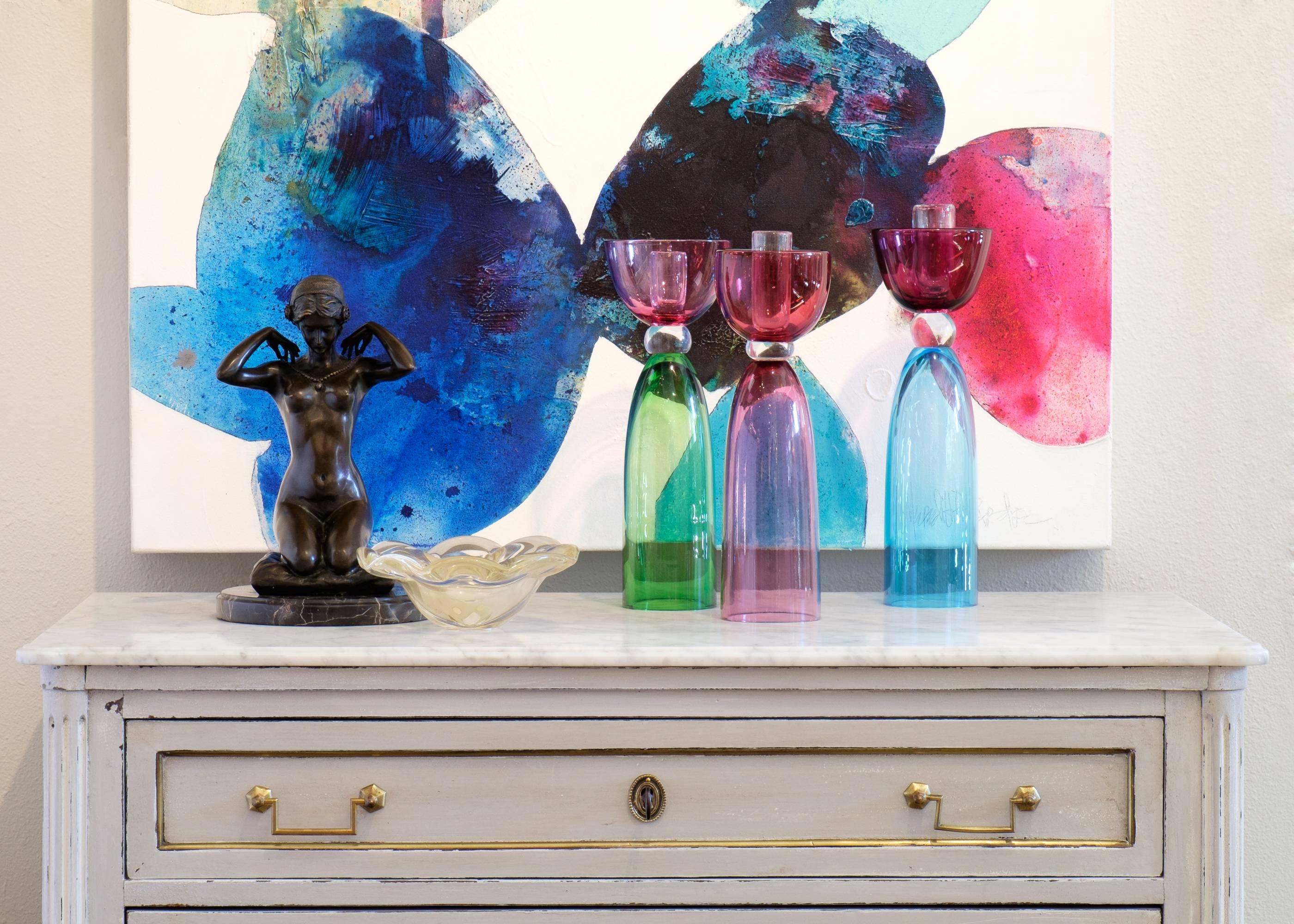 Vintage Italian set of three Murano glass candlesticks in pink amethyst, cerulean blue, and spring green with crystal clear accents. Such good colors.