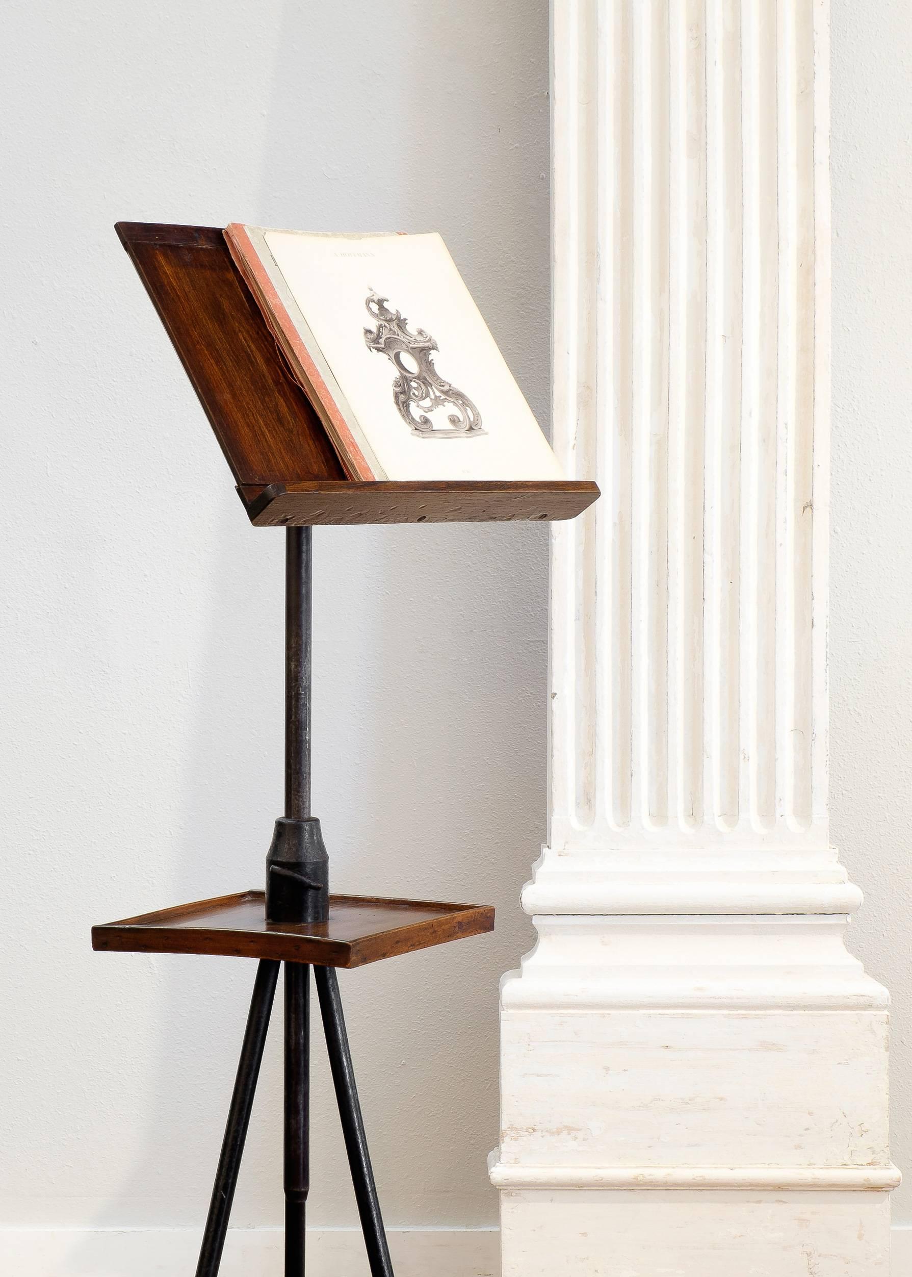 French antique lectern of cast iron with solid oak sand and shelf, adjustable height and inclination cast iron system. This unique, custom piece could be used as a music stand as well.