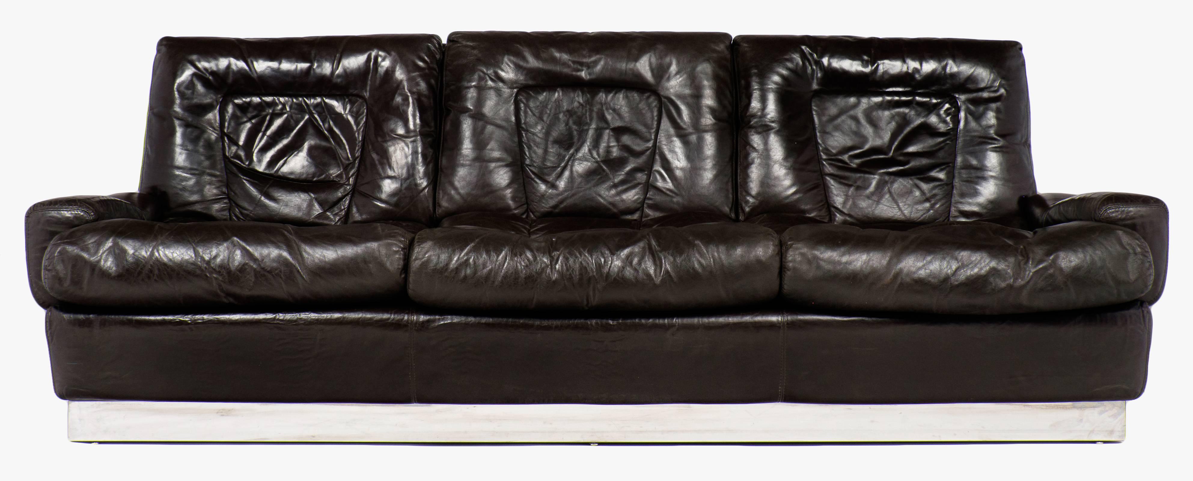 A modernist piece with ultimate comfort in mind, a vintage French leather sofa by Jacques Charpentier with plush dark walnut brown leather cushions and a chrome silver metal base. Measures: The seat height is 15.75.