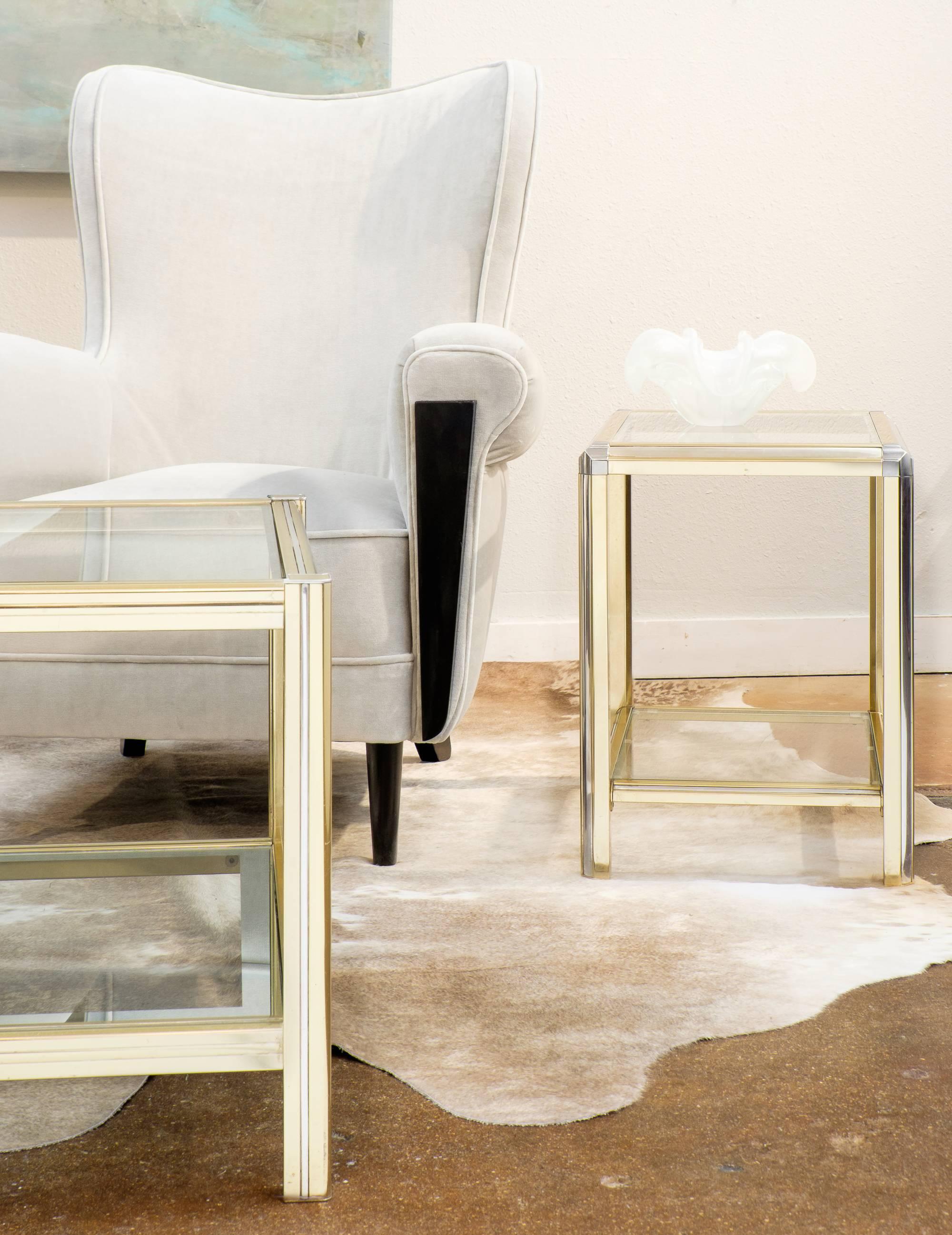 A chic pair of vintage French brass and chrome glass top small side tables. An elegant interplay of mixed metals that works well with other chrome or brass pieces. This gleaming pair are also perfectly sized for display use.