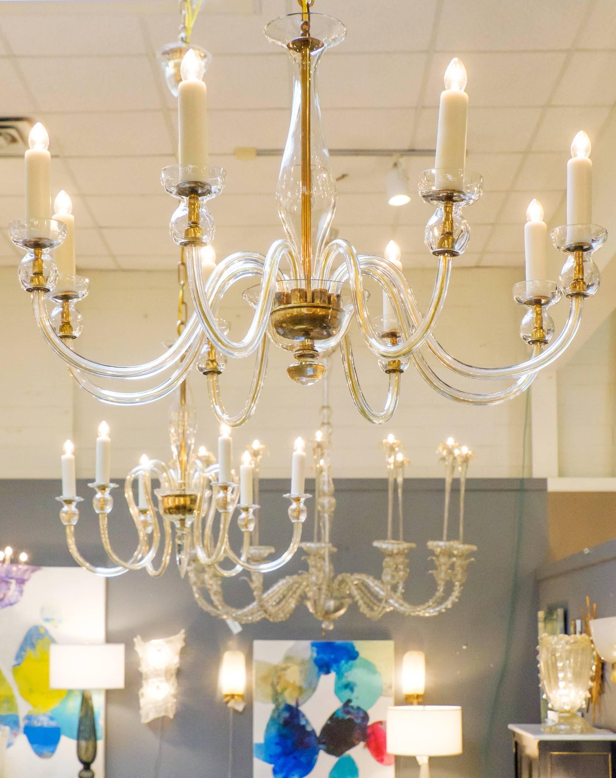 A beautiful and elegant modernist take, this Murano amber glass eight-arm chandelier is a perfect piece for dining rooms, foyers and seating areas. This lighting piece makes a sophisticated style statement that creates an intimate environment for a