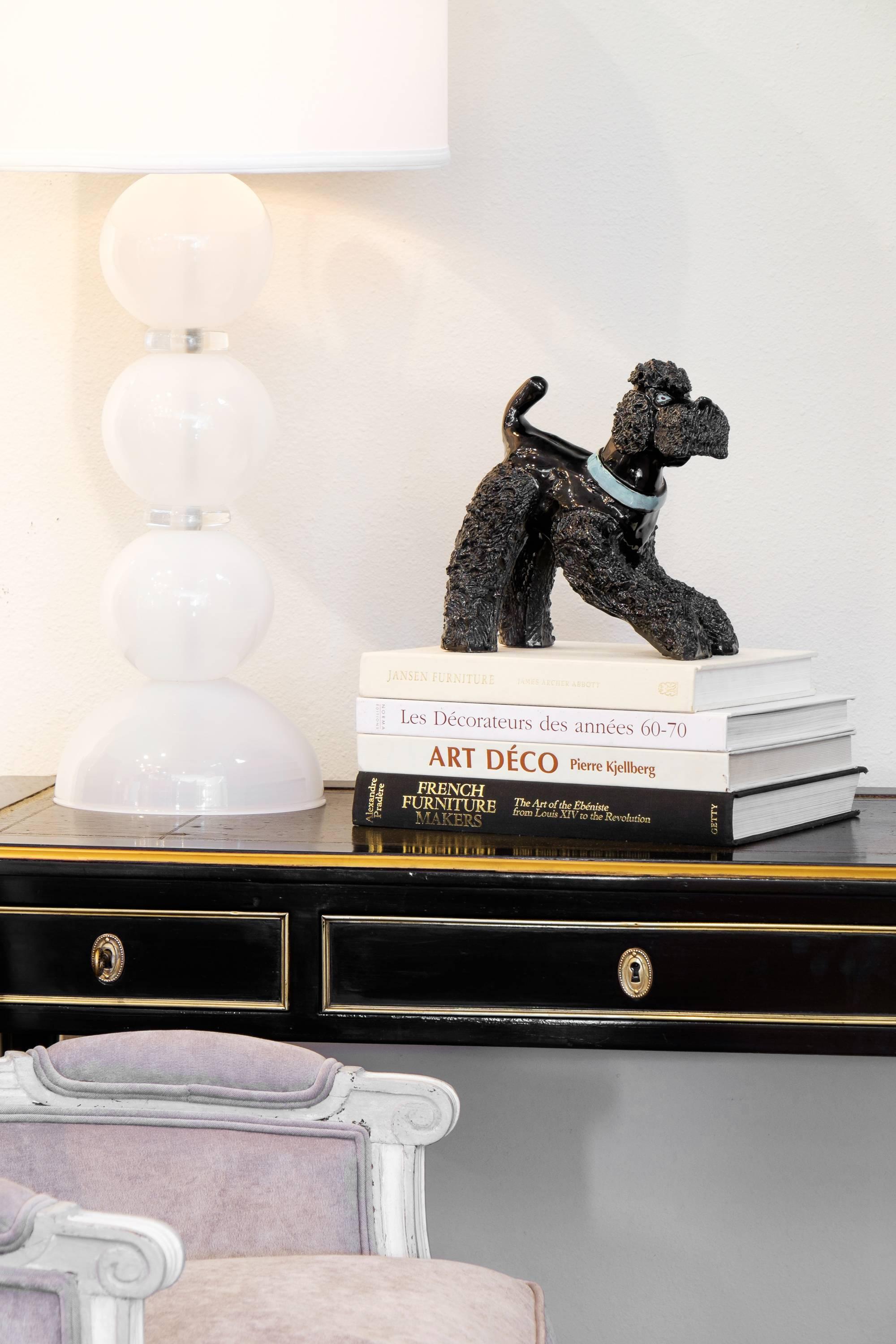 An adorable French Art Deco black poodle ceramic sculpture intricately detailed by hand with a pop of blue. The perfect art piece to honor that special best friend in your life.