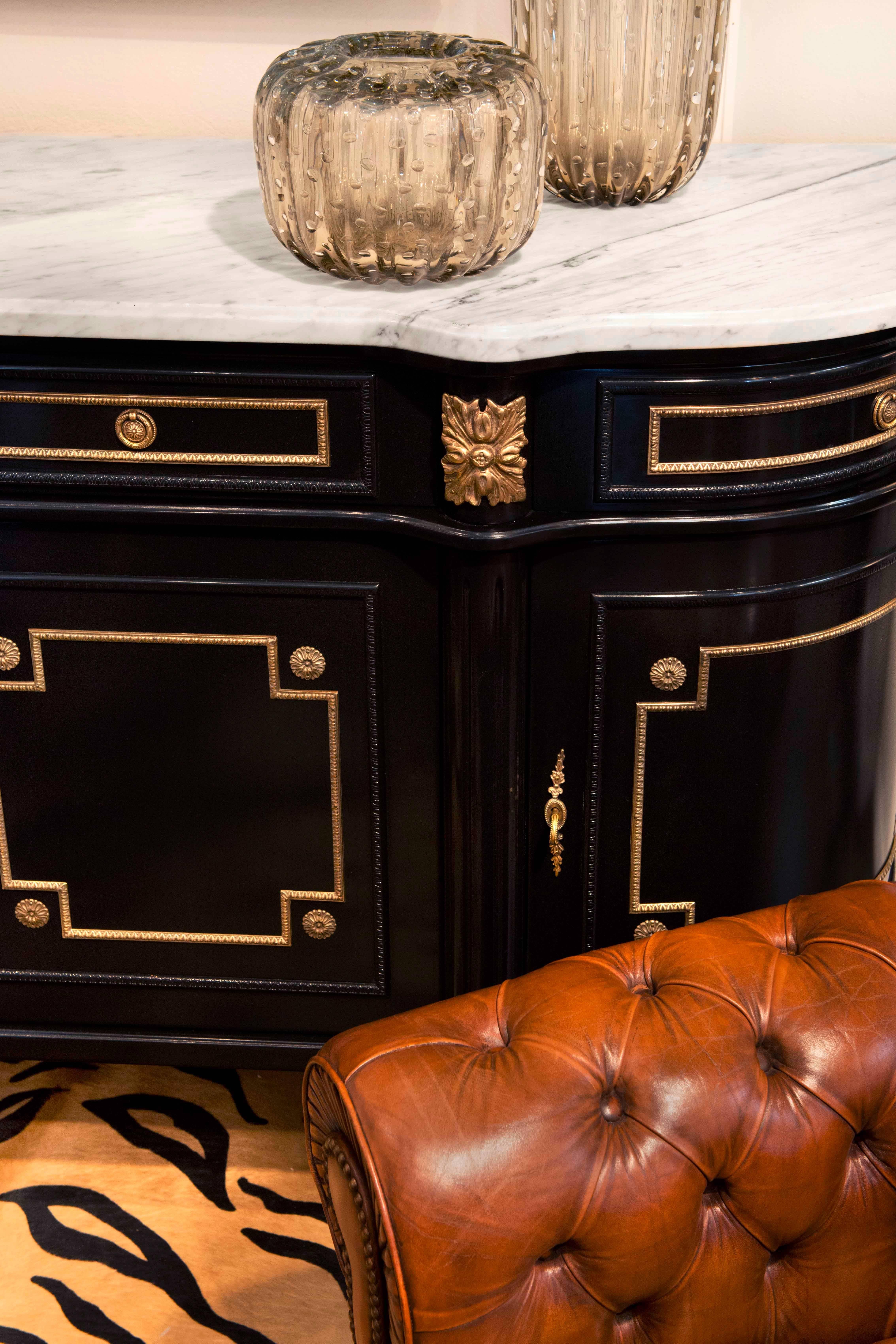 French antique buffet or enfilade of mahogany finished with a lustrous French polish. Topped with a thick slab of Carrara marble, gilt brass hardware and trim throughout. Fluted columns and feet with gilt brass caps. A spectacular craftsmanship for