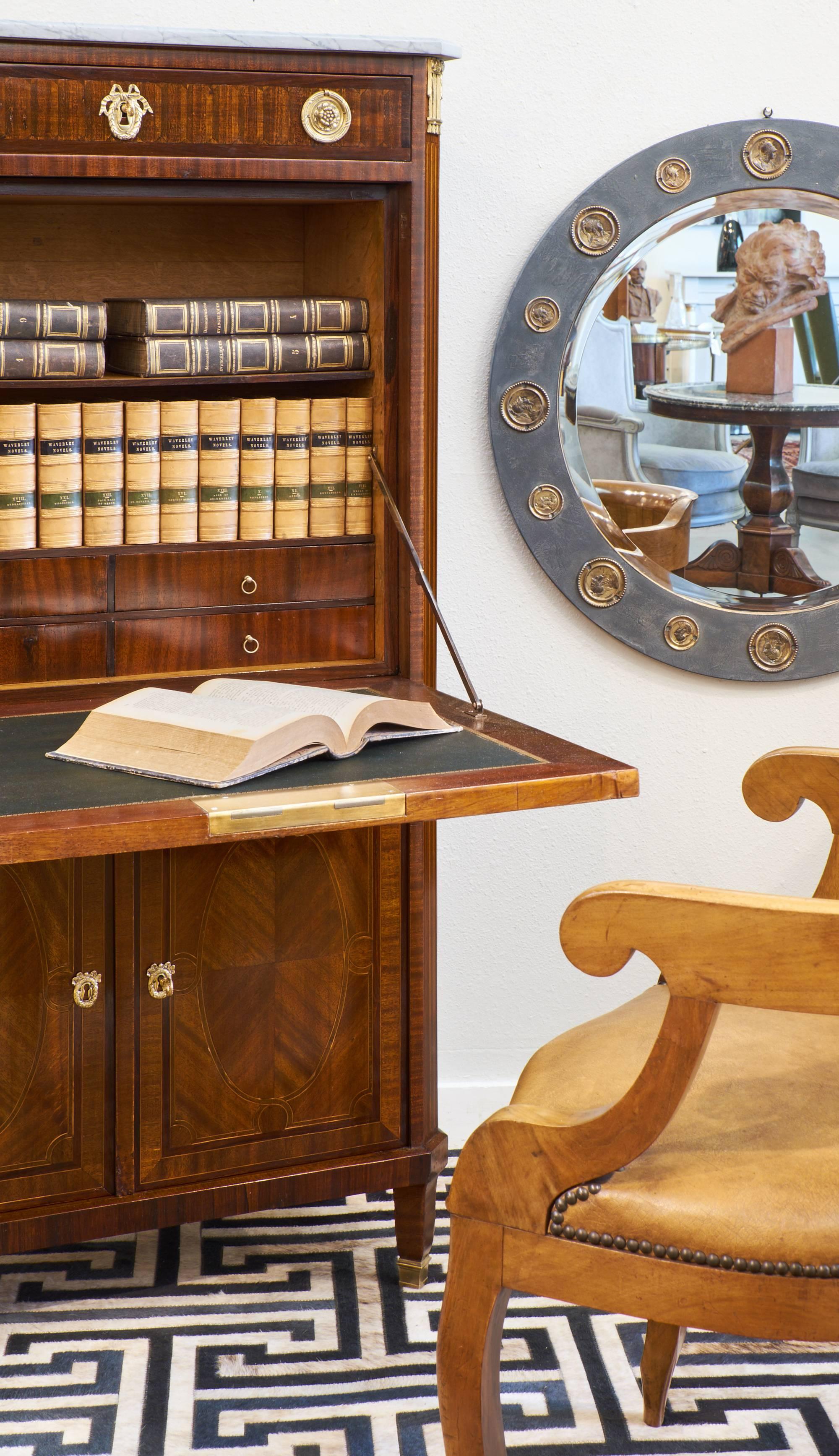 A superb finely crafted Louis XVI style secretary desk with its original Carrara marble top and gilded bronze hardware. Intricate work of marquetry and inlays in rosewood, tinted rosewood and ebony. Depth with dropfront opened 36.75.
The piece