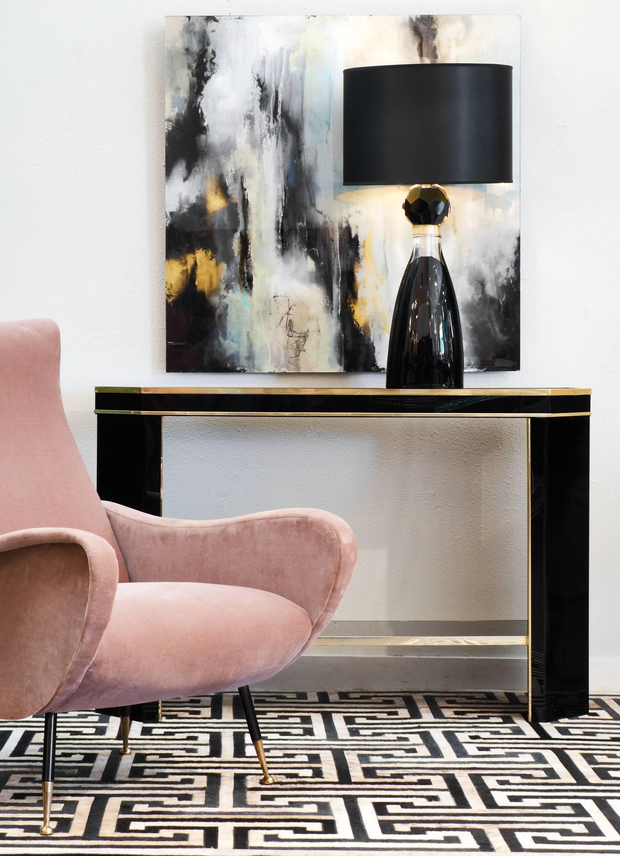 French vintage black Lucite console table with brass trim, black opaline glass top and bottom shelf.