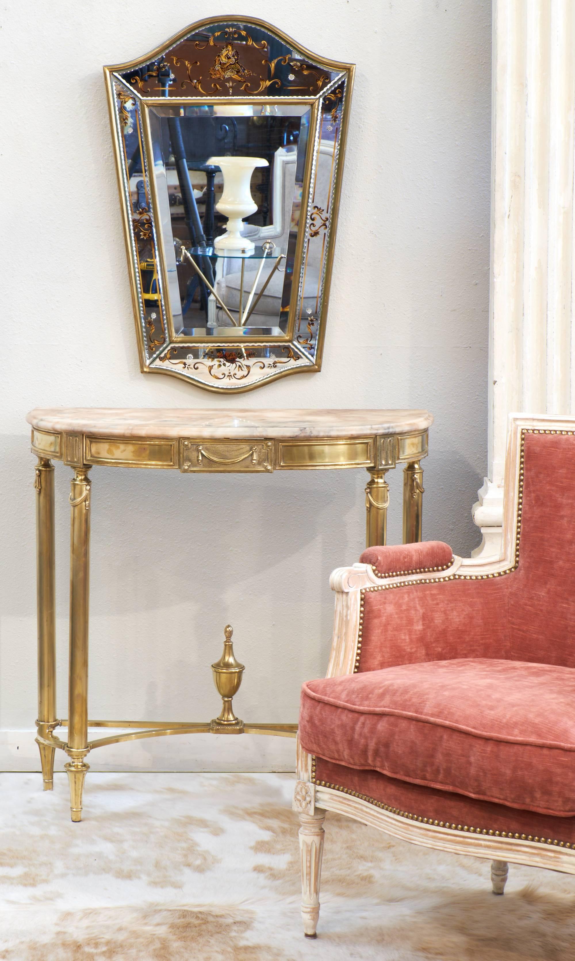 French vintage neoclassical style demilune console table decorated with hanging laurel garlands and a classical urn on the stretcher. Marble top and brass base with 