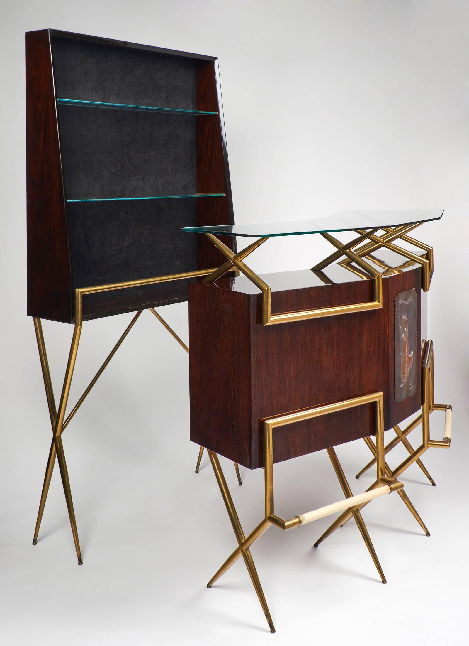 Italian vintage standing shelving in the manner of Paolo Buffa. Rich, high-gloss lacquered mahogany, brass and glass come together in perfect harmony for this Mid-Century piece. The case piece stands tall on tapered brass legs, with two glass