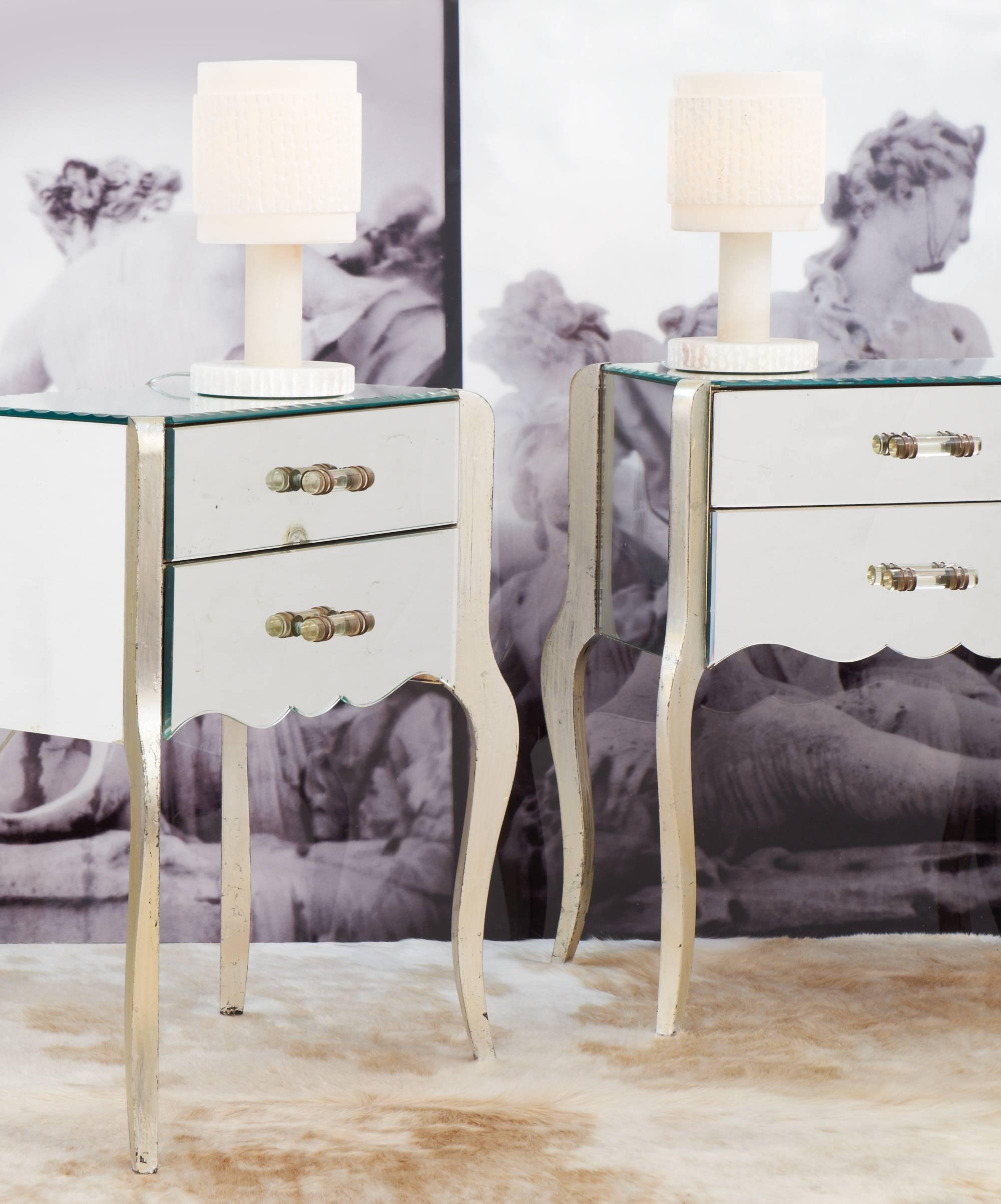 Precious Vintage French pair of side tables or nightstands with mirrored tops, sides and drawers. Mirrored tops have scalloped edges. Silver leafed legs and original glass rod handles on two drawers for each end table. Charming and feminine, these