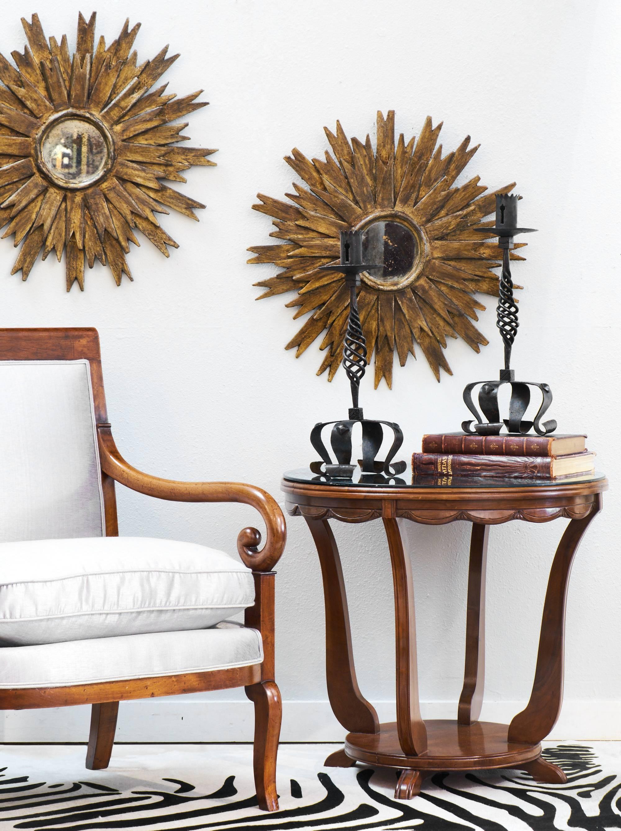 French Art Deco period gueridon of French polished walnut with antiqued mirror top. Exquisite detailing on this vintage side table includes an apron adorned with carved garlands and fluting on the top edge, legs and bottom shelf.